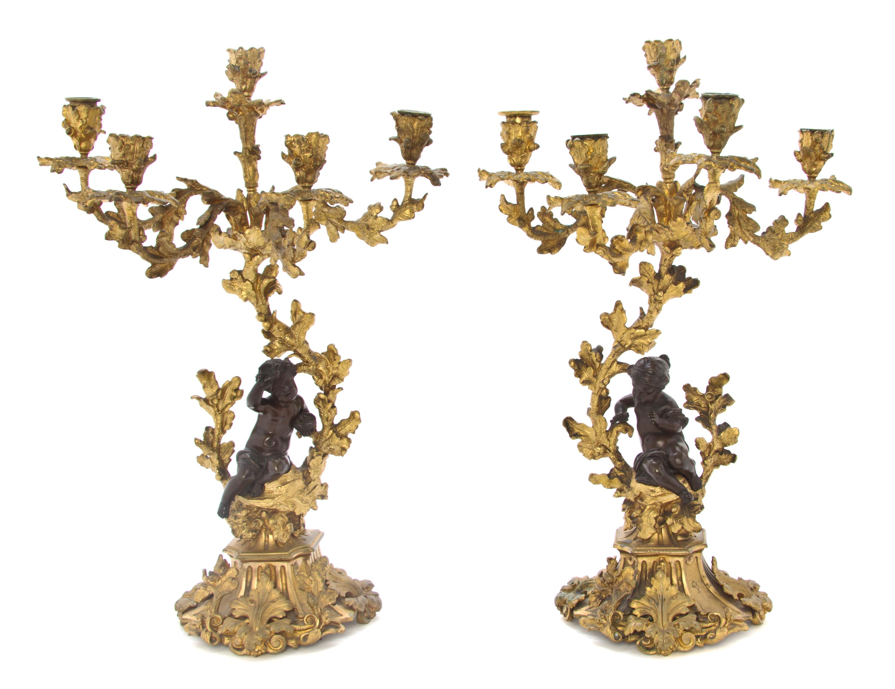 A Pair of Neoclassical Patinated Bronze Five-Light Figural Candelabra, Height 21 inches.