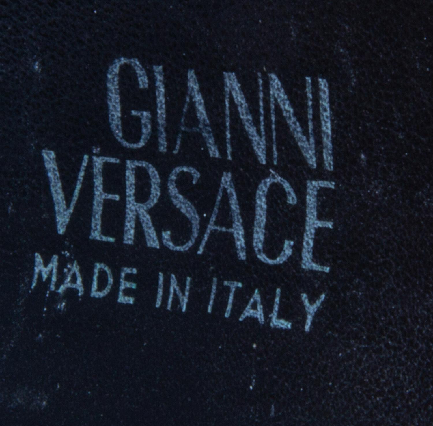 A Gianni Versace Black Leather Star Cuff with Matching Single Earclip, Width: 3"; Diameter: 7.75"- 8.75"; Earclip: 1" x 1".