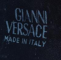A Gianni Versace Black Leather Star Cuff with Matching Single Earclip, Width: 3"; Diameter: 7.75"- 8.75"; Earclip: 1" x 1".