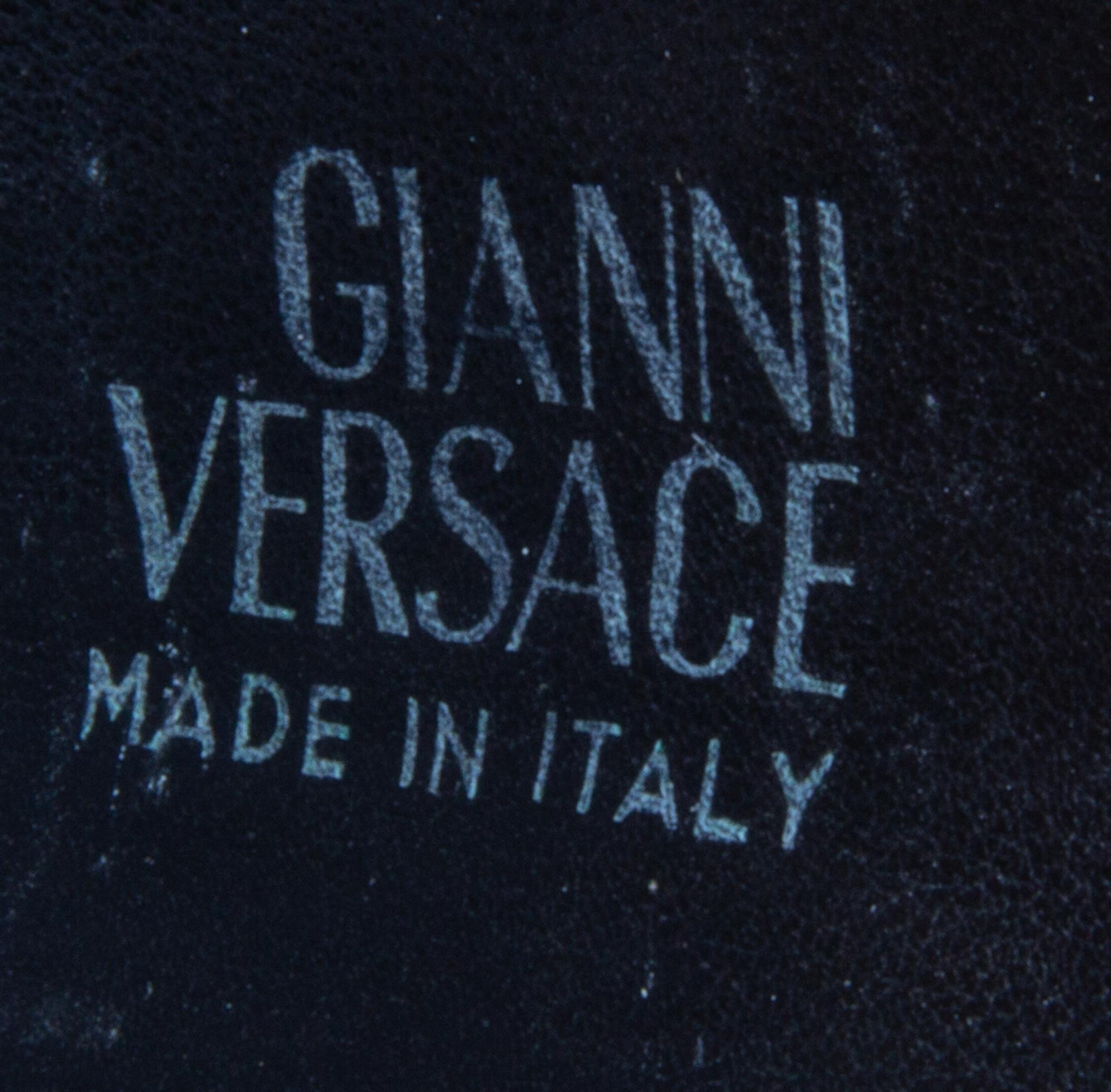 A Gianni Versace Black Leather Star Cuff with Matching Single Earclip, Width: 3"; Diameter: 7.75"- 8.75"; Earclip: 1" x 1".