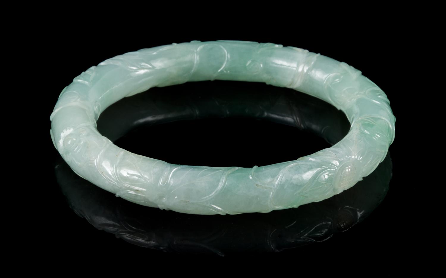 An Apple Green and Celadon Jadeite Bangle Interor diameter 2 1/4 inches.