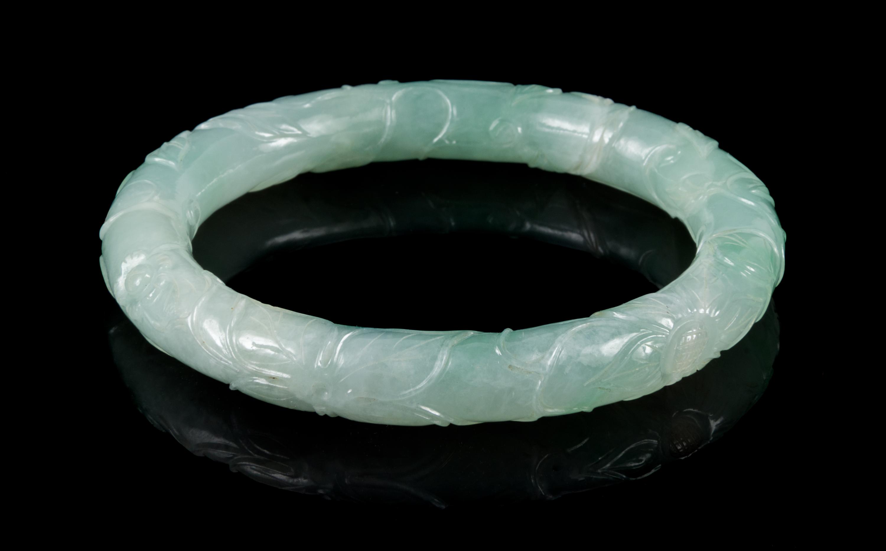 An Apple Green and Celadon Jadeite Bangle Interor diameter 2 1/4 inches.
