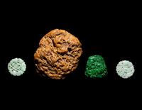 A Chinese Soapstone Boulder and Three Green Jade and Jadeite Pendants