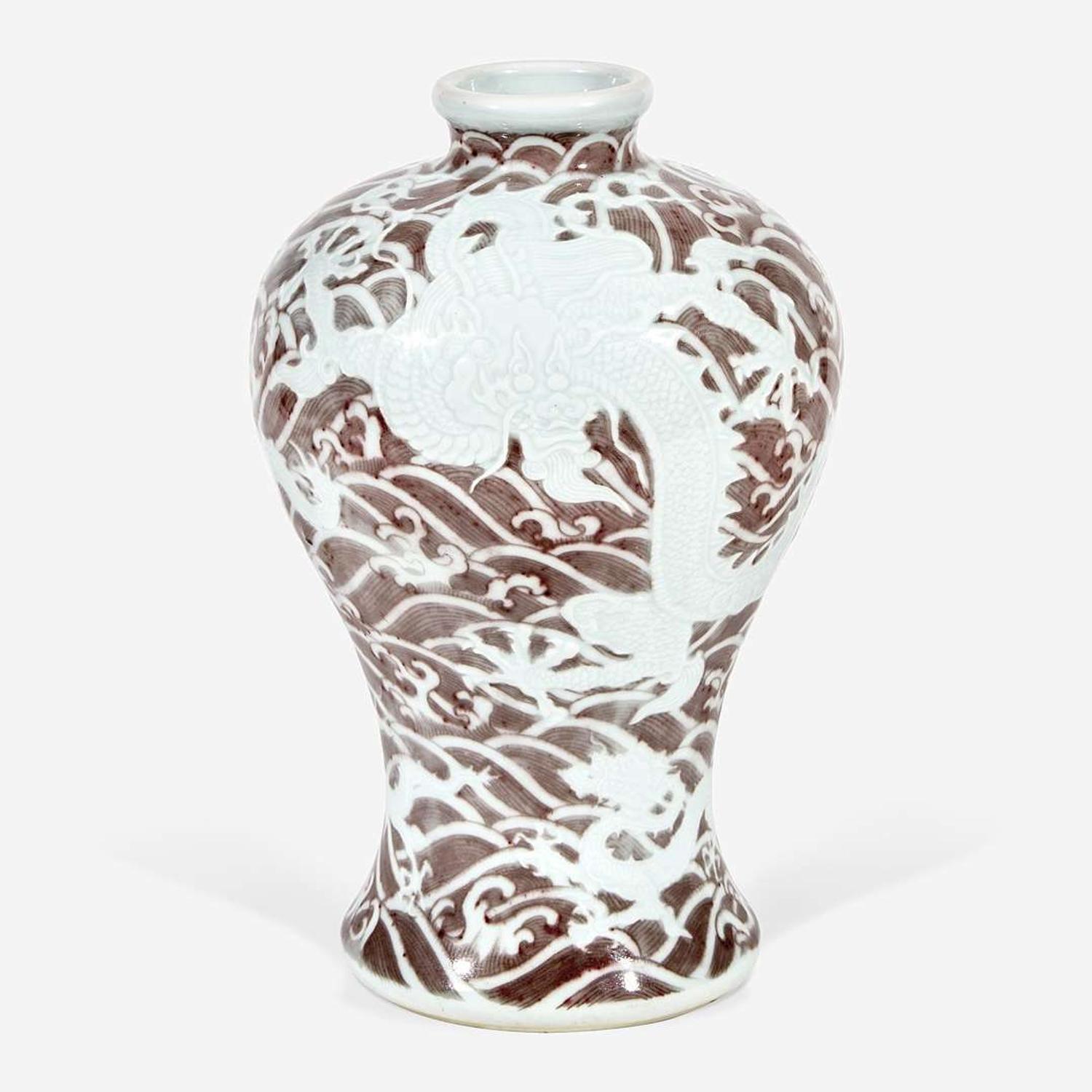A Chinese carved and underglaze red "Dragons and Waves" vase, Meiping Yongzheng six-character mark and of the period