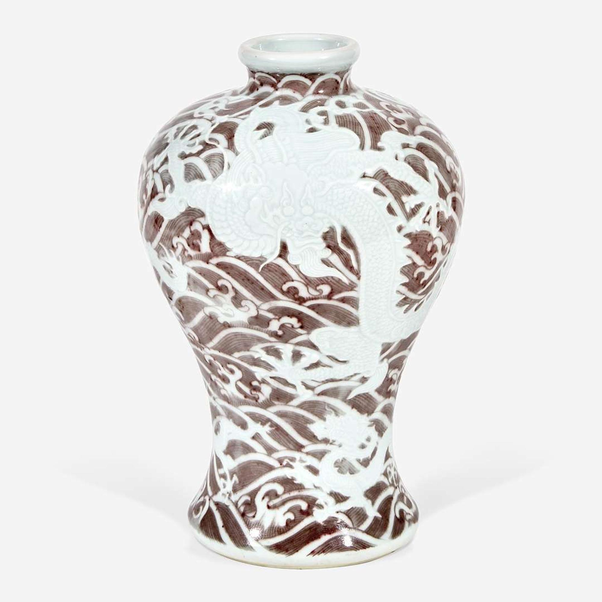 A Chinese carved and underglaze red "Dragons and Waves" vase, Meiping Yongzheng six-character mark and of the period
