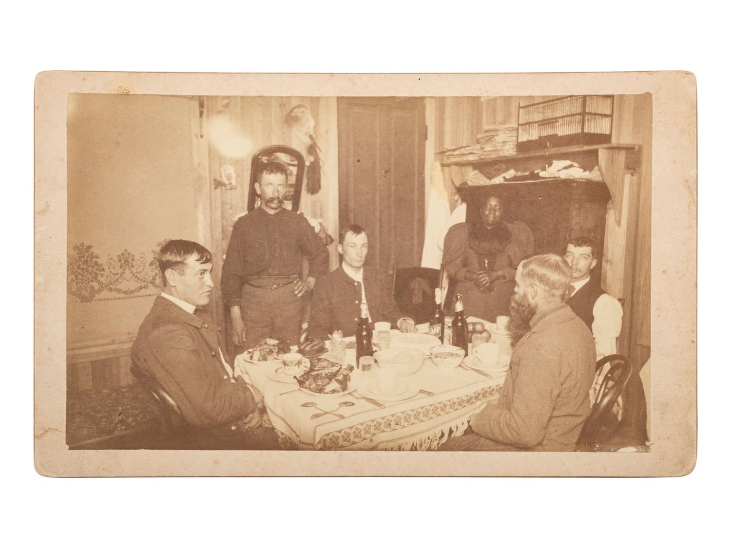 African Americana Boudoir card featuring a a group of white soldiers being served by an African American servant. Fort Sill, Oklahoma Territory.