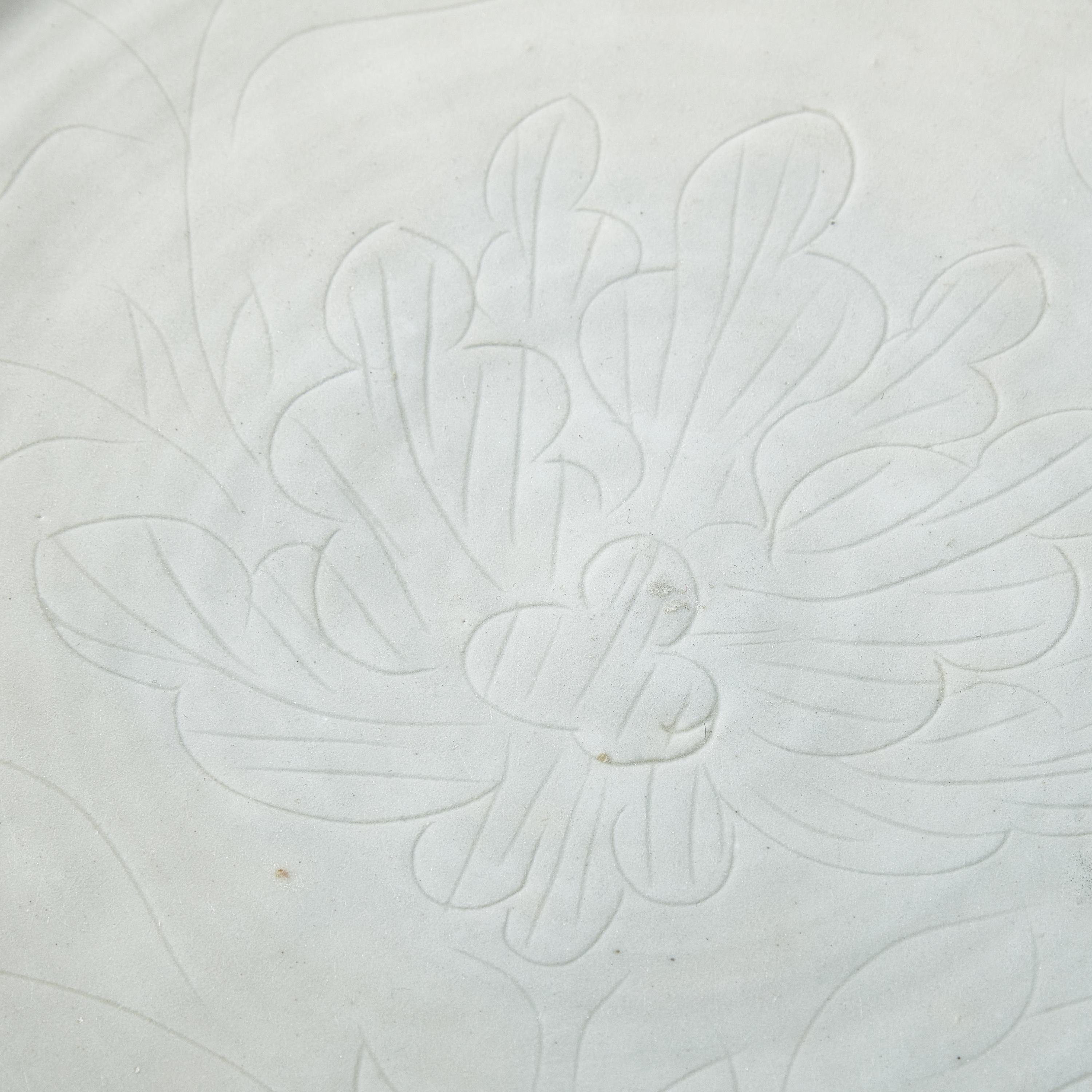 Two Large Chinese Incised Blanc-de-Chine Porcelain 'Floral' Dishes, 17th Century — 清早中期 德化白瓷暗刻花卉紋盤兩件
