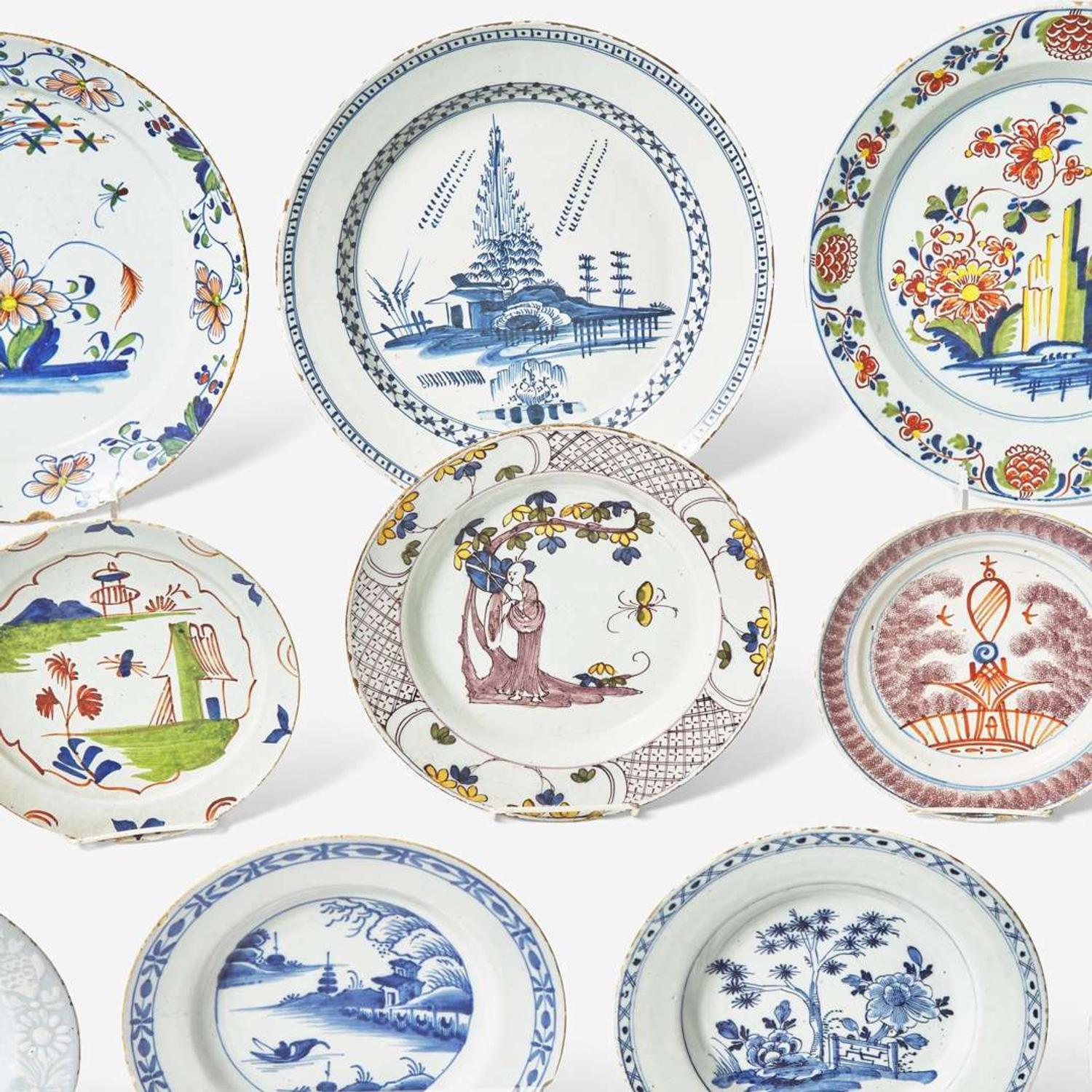 A collection of fourteen English Delft or tin-glazed earthenware plates 18th century