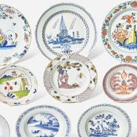 A collection of fourteen English Delft or tin-glazed earthenware plates 18th century