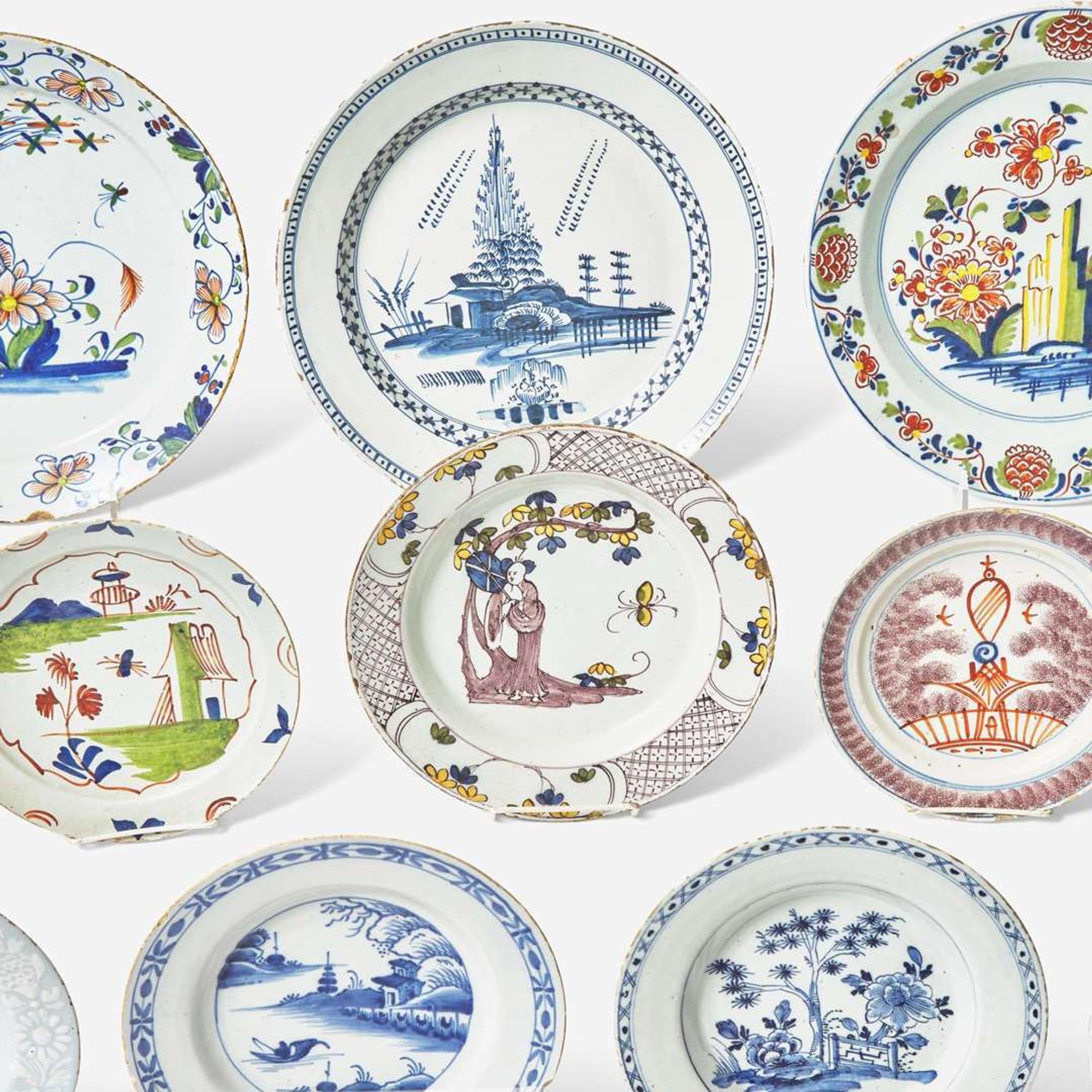 A collection of fourteen English Delft or tin-glazed earthenware plates 18th century