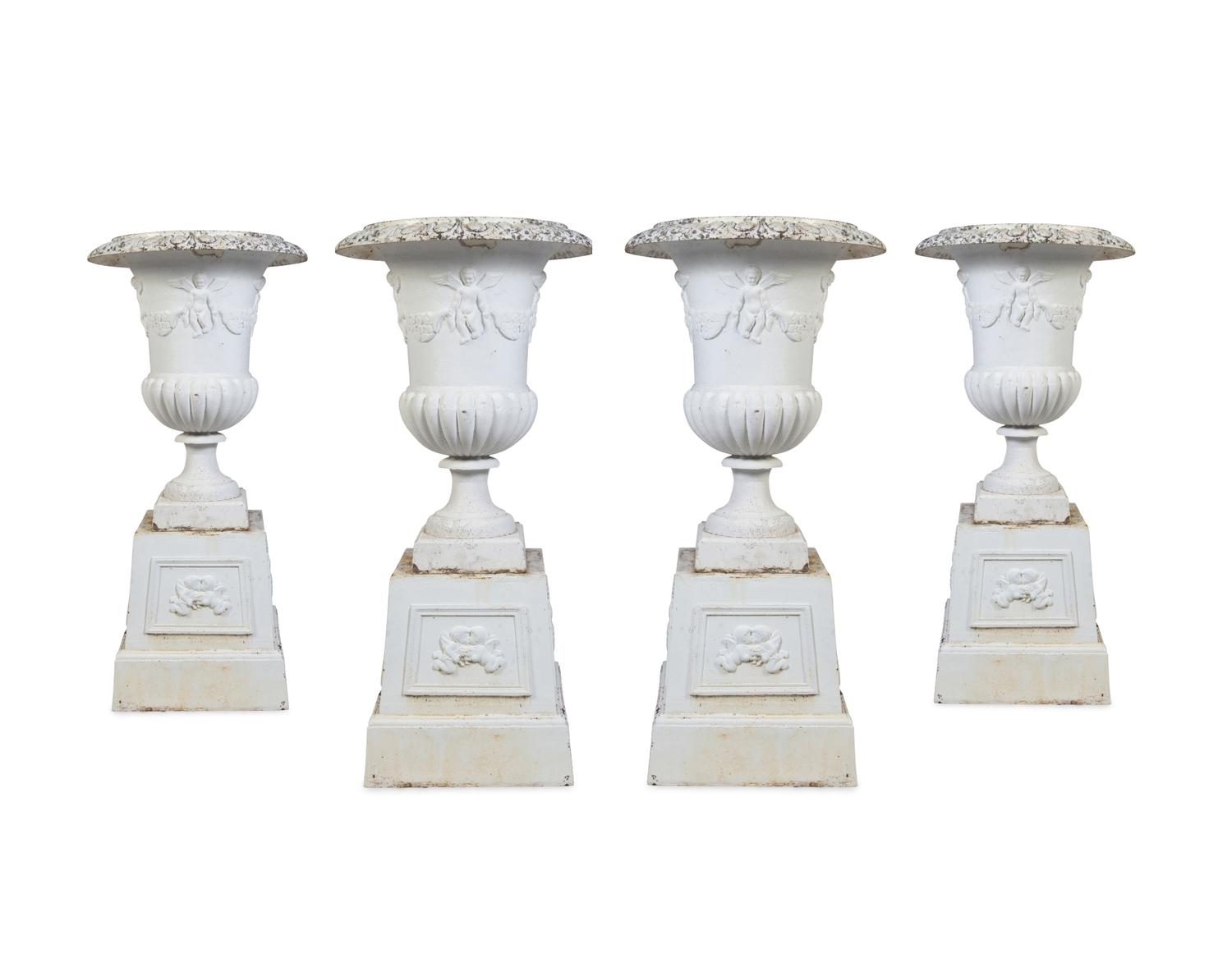 A Set of Four Victorian Style Painted Cast Iron Urns and Plinths