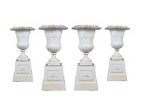 A Set of Four Victorian Style Painted Cast Iron Urns and Plinths