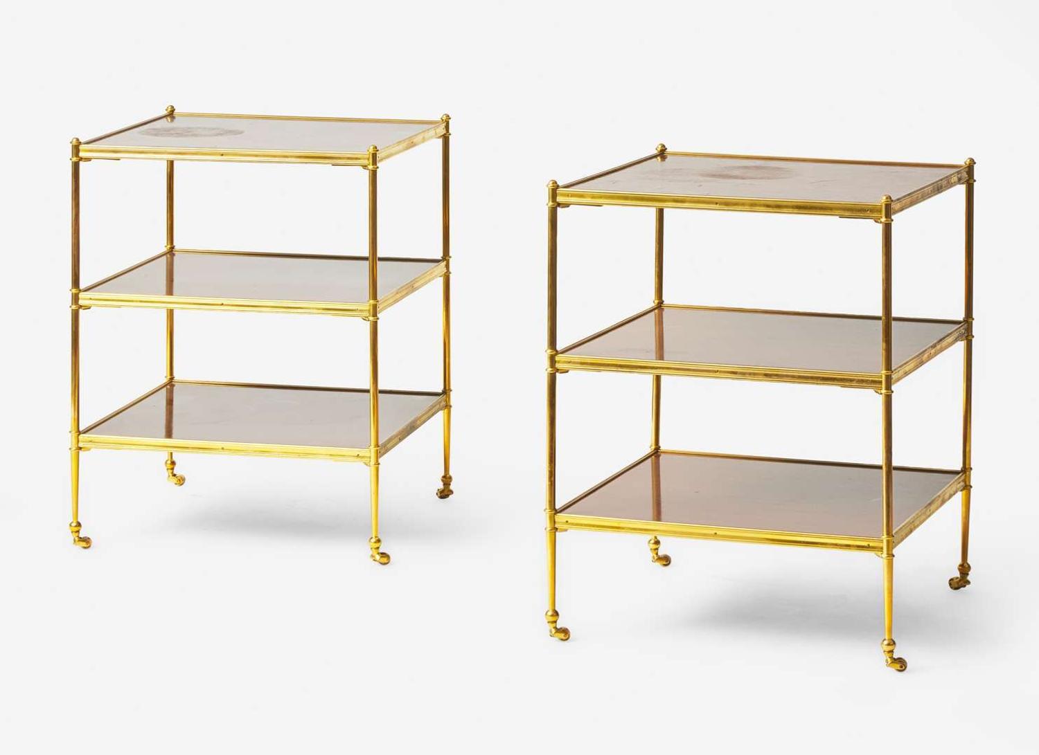 A pair of French gilt bronze and mahogany three-tiered side tables, in the manner of Maison Jansen, 20th century