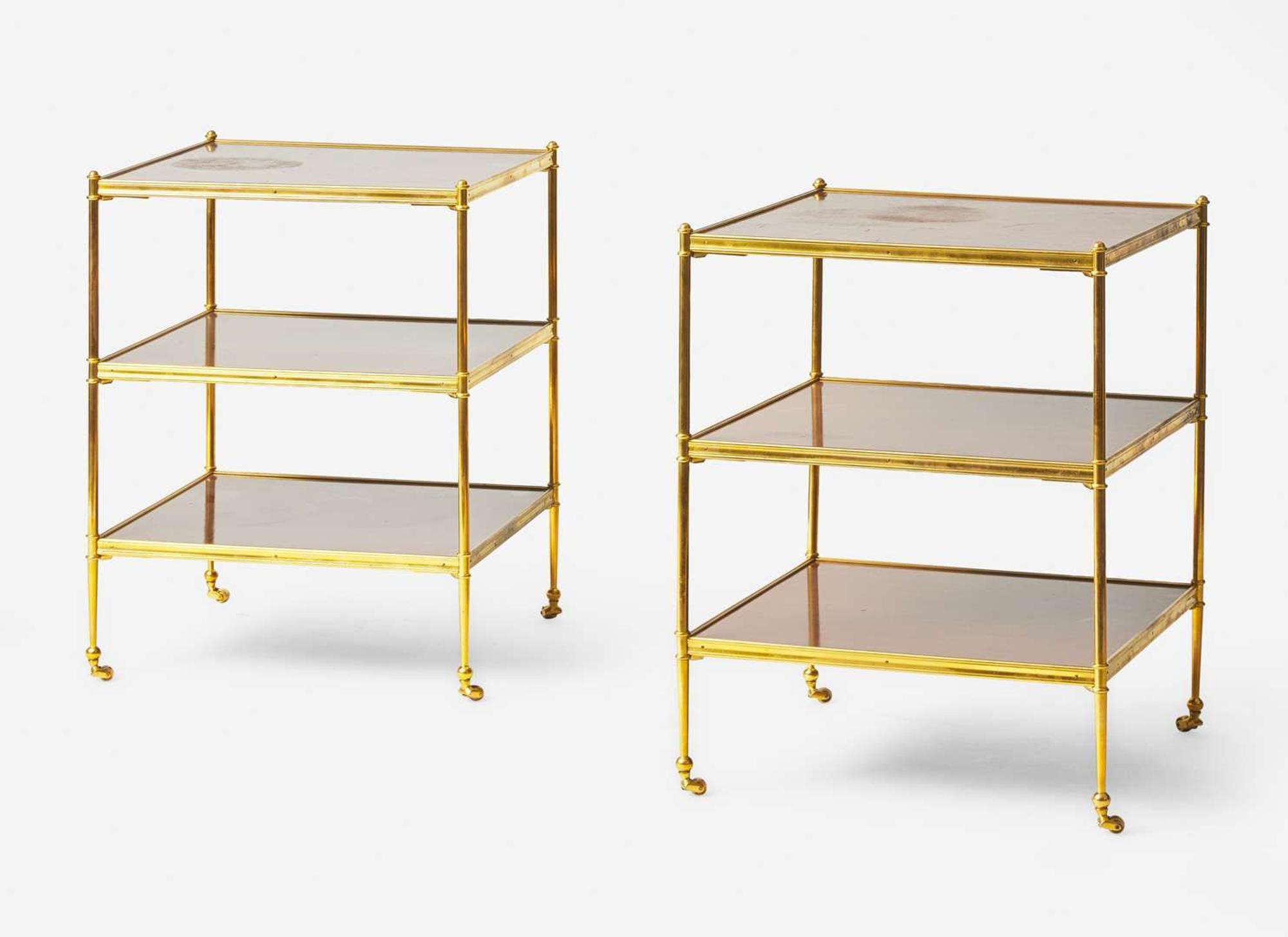 A pair of French gilt bronze and mahogany three-tiered side tables, in the manner of Maison Jansen, 20th century
