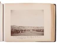 Exceptional album containing photographs of Pine Ridge Reservation and its surroundings, incl. Native American subjects, Indian schools, ceremonies, camp life, and Wounded Knee. Ca late 1890s-early 1900s.