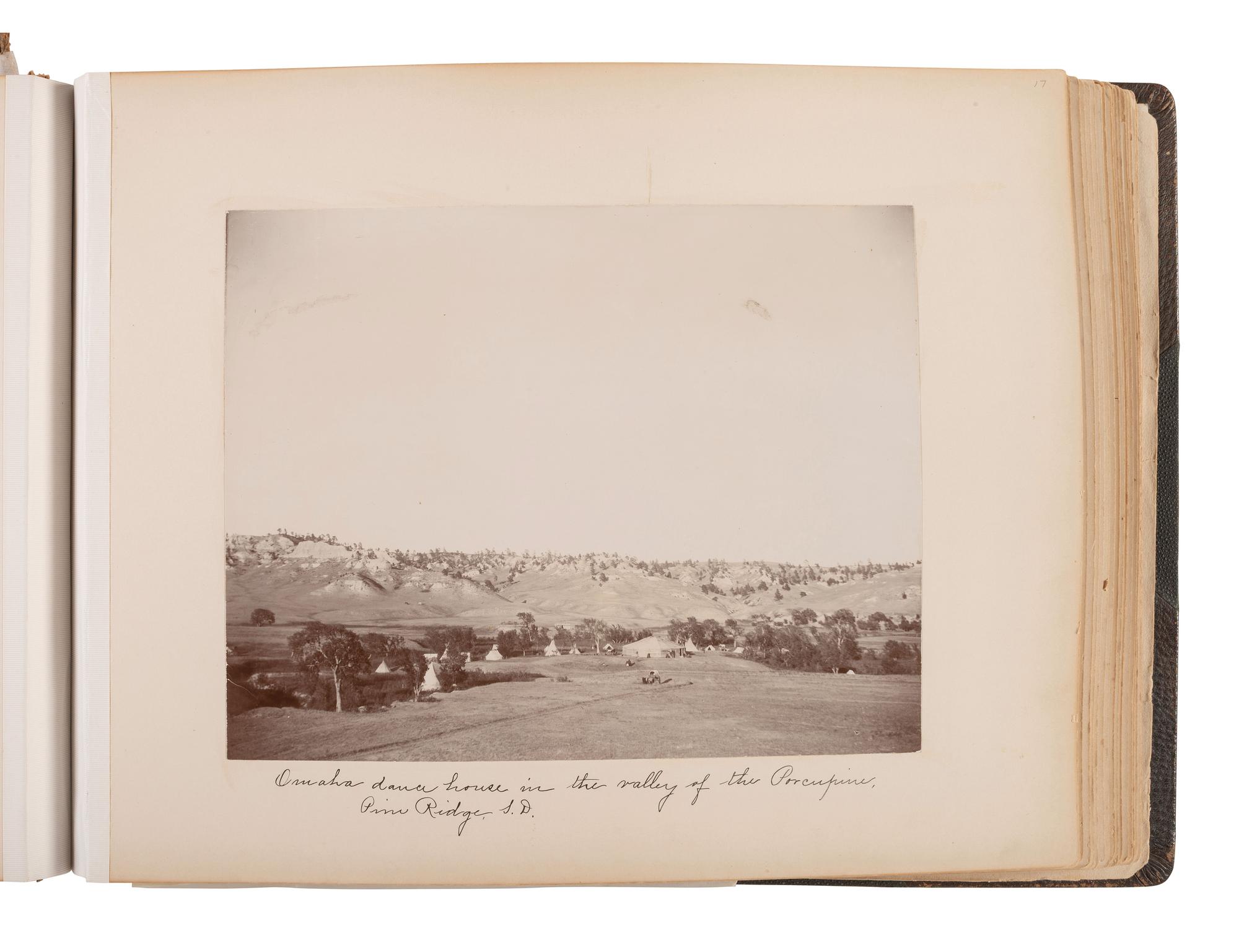 Exceptional album containing photographs of Pine Ridge Reservation and its surroundings, incl. Native American subjects, Indian schools, ceremonies, camp life, and Wounded Knee. Ca late 1890s-early 1900s.