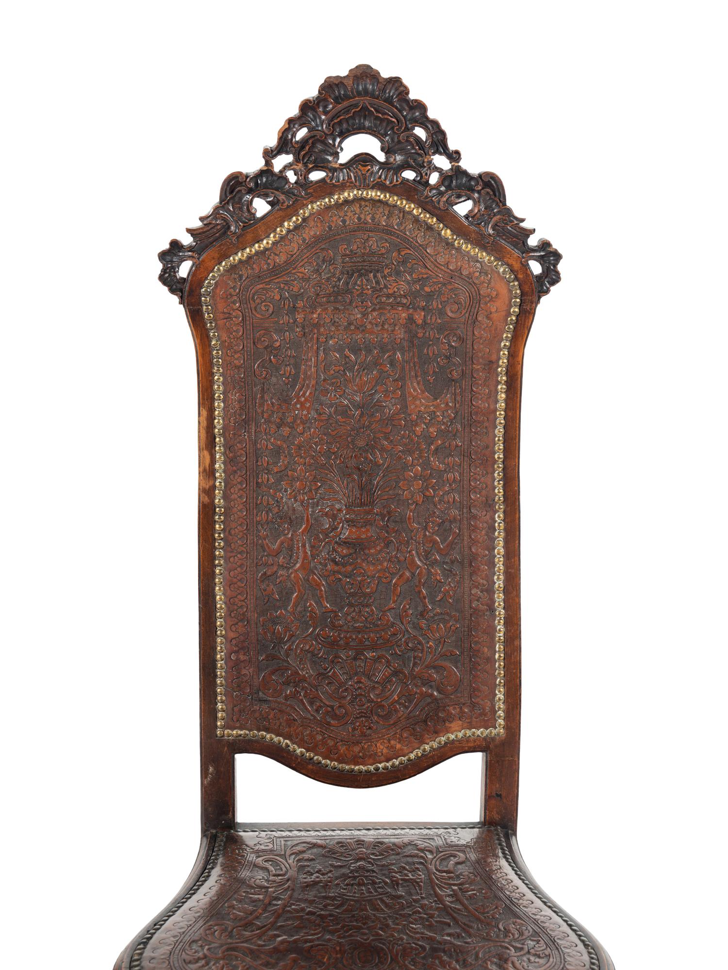 A Pair of Portuguese Carved Walnut and Tooled Leather Hall Chairs