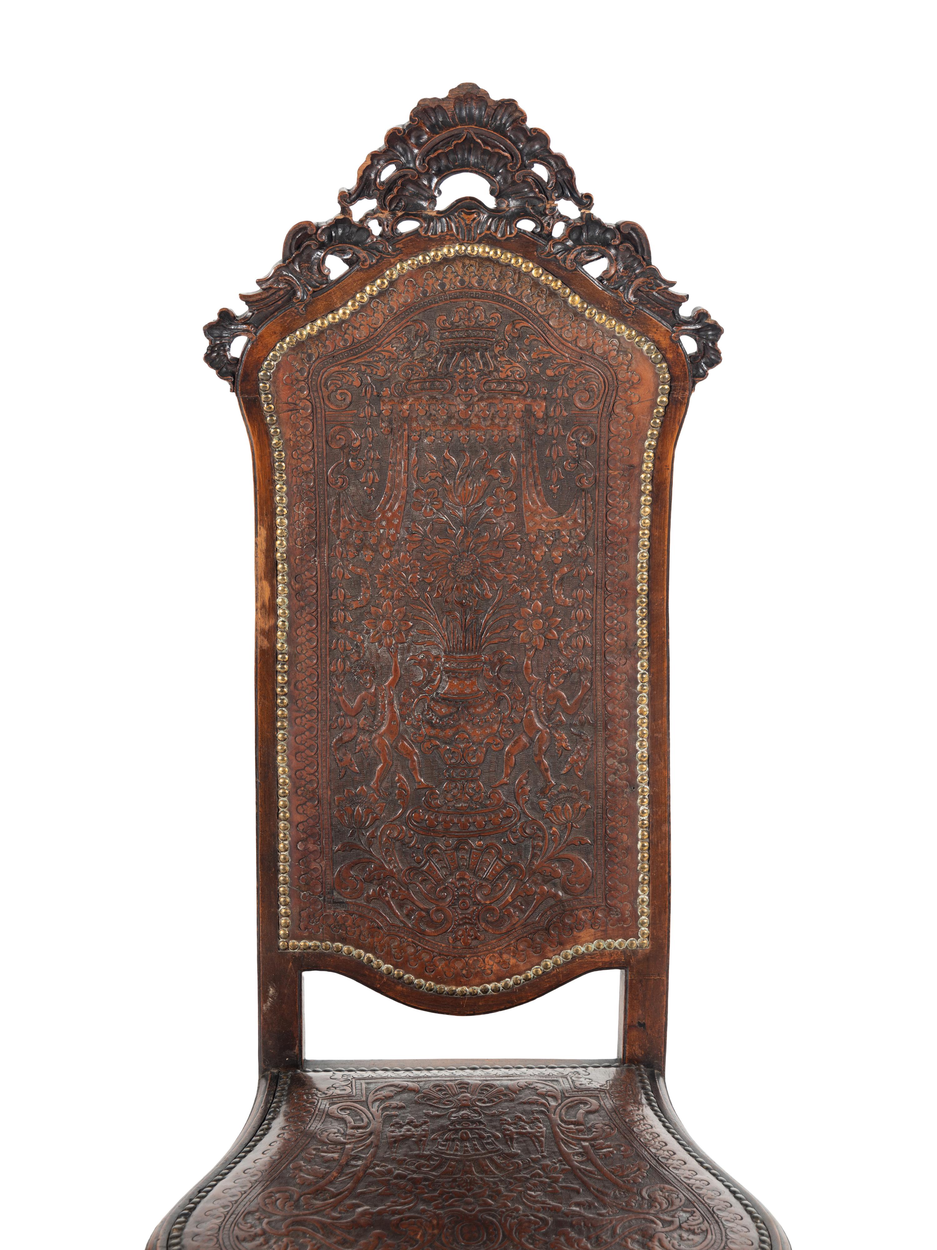 A Pair of Portuguese Carved Walnut and Tooled Leather Hall Chairs