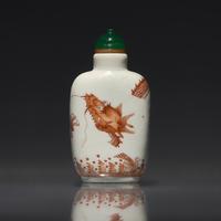 A Chinese Enameled Porcelain "Dragon" Snuff Bottle, Qing Dynasty, Daoguang Period — 清道光 瓷胎礬紅刻暗花龍紋鼻煙壺