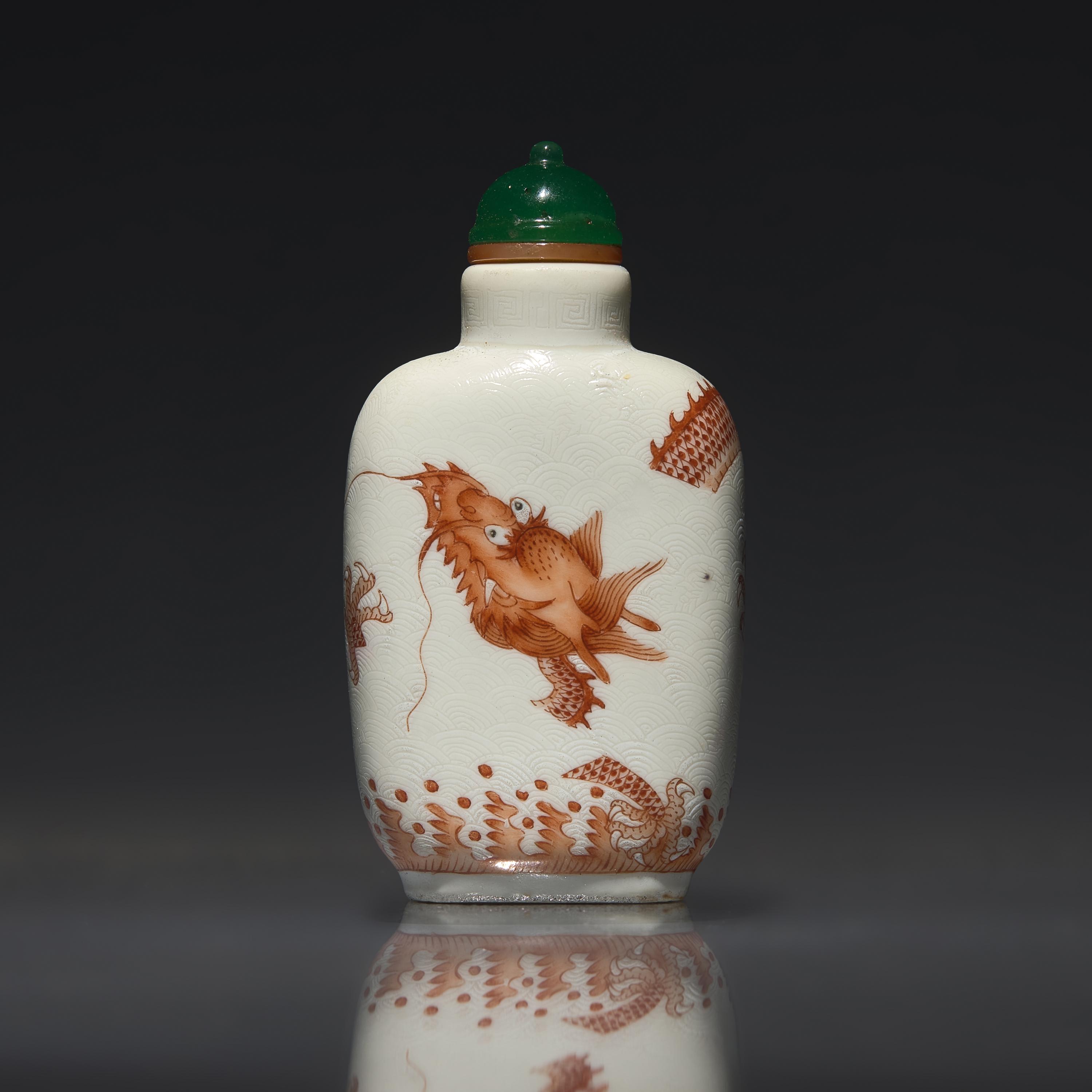 A Chinese Enameled Porcelain "Dragon" Snuff Bottle, Qing Dynasty, Daoguang Period — 清道光 瓷胎礬紅刻暗花龍紋鼻煙壺