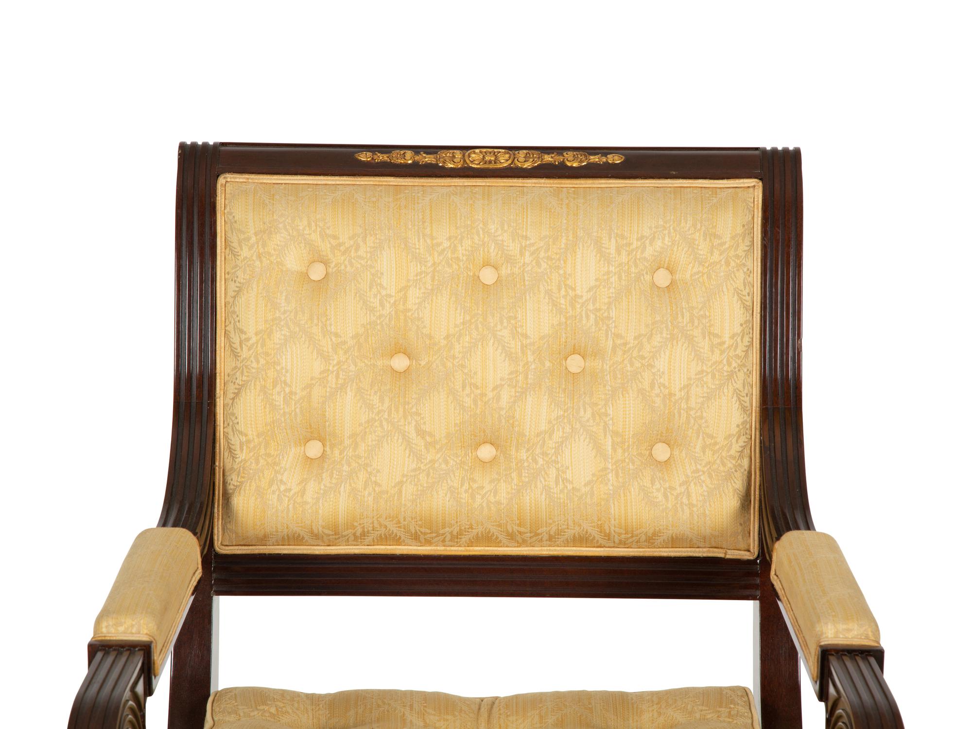 A French Empire Style Mahogany and Parcel Gilt Fauteuil