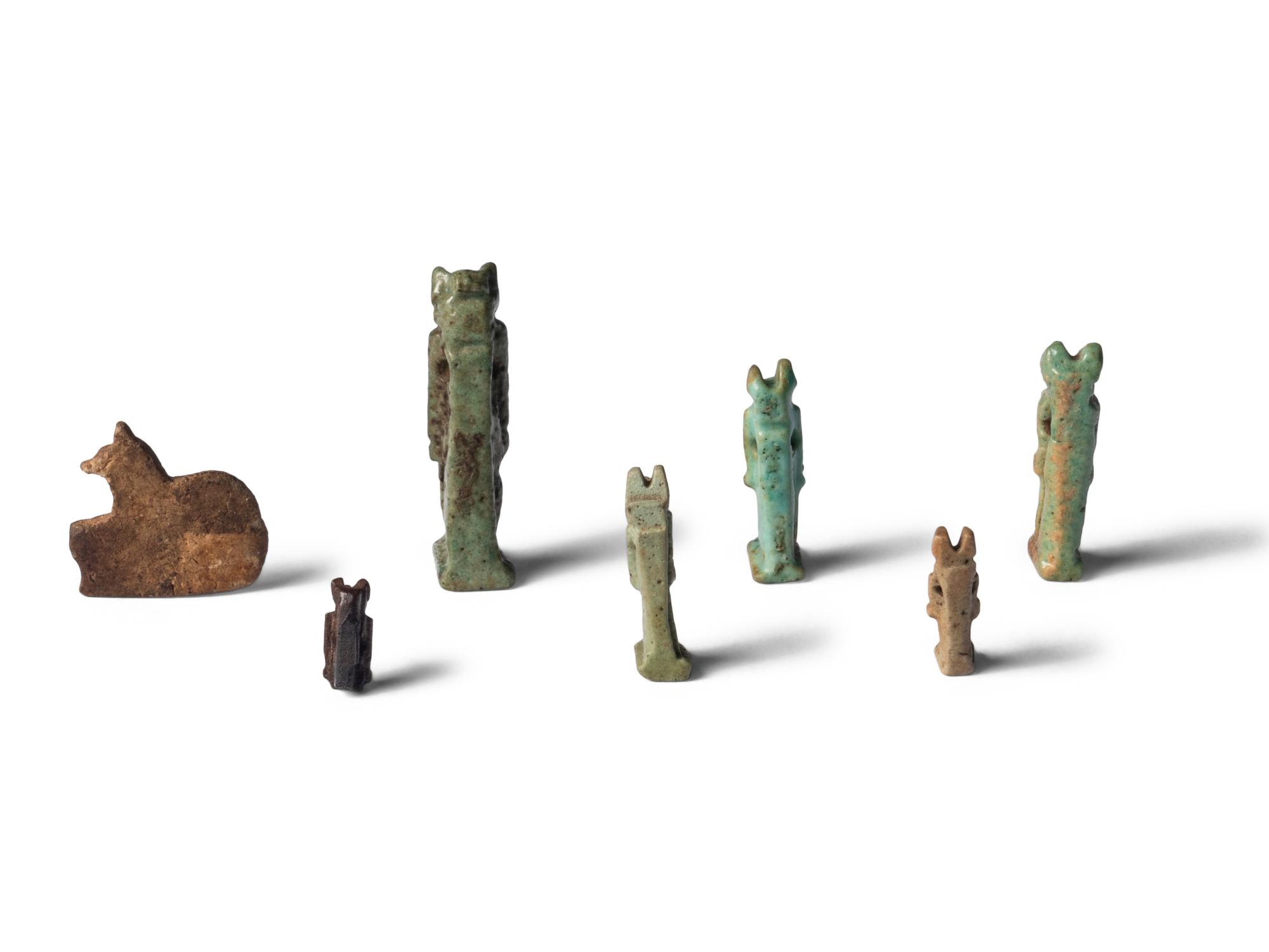 Seven Egyptian Faience and Stone Anubis Amulets