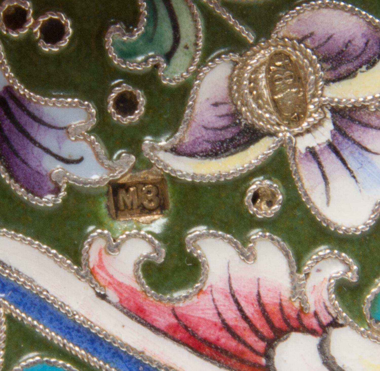 A Russian Enameled Silver Cigarette Case, Mark of Mikhail Zorin, Moscow, early 20th century, the case decorated with a central floral a