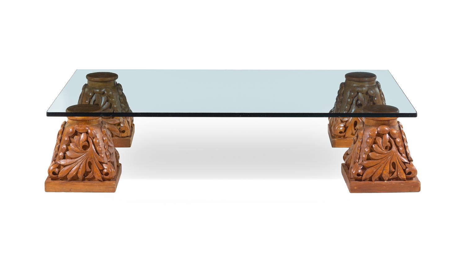 A Set of Four Carved Oak Capitals with a Glass Top as a Low Table