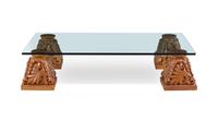 A Set of Four Carved Oak Capitals with a Glass Top as a Low Table