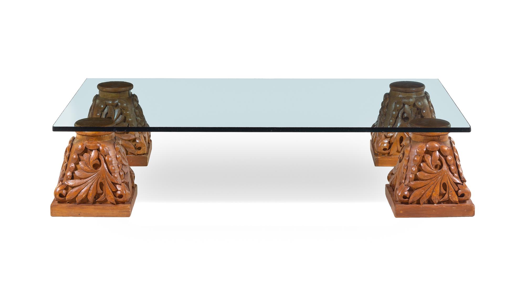 A Set of Four Carved Oak Capitals with a Glass Top as a Low Table