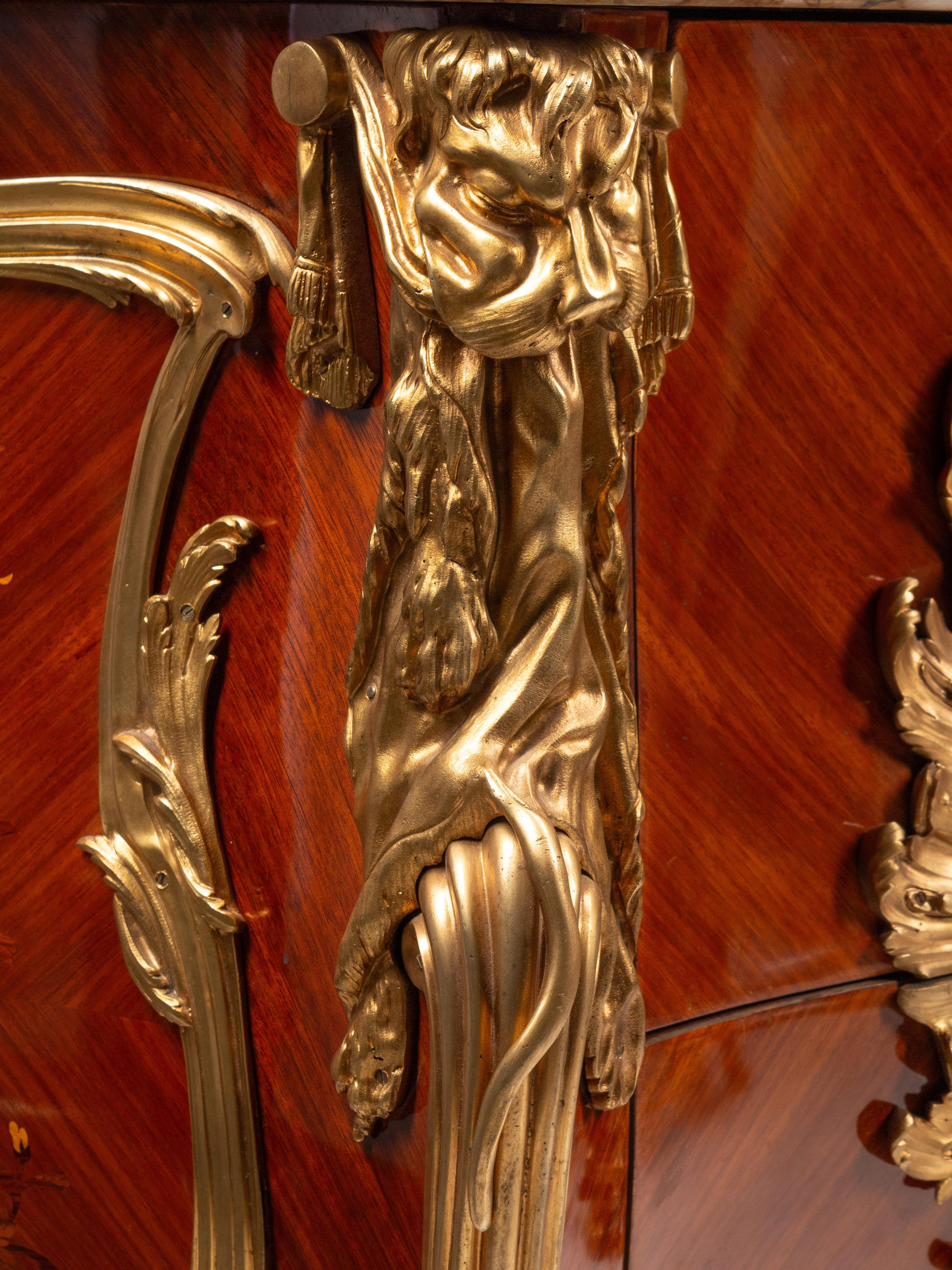 A Pair of Louis XV Style Gilt Bronze Mounted Kingwood and Floral Marquetry Marble-Top Commodes