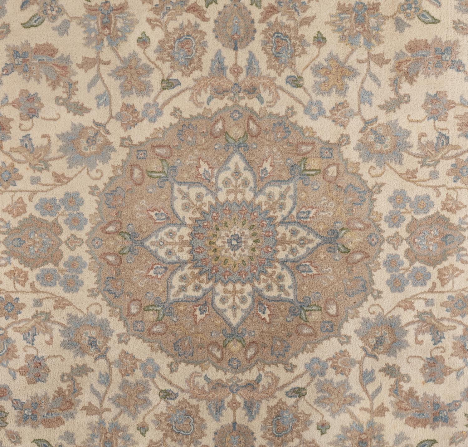 An Ivory and Pastel Rug