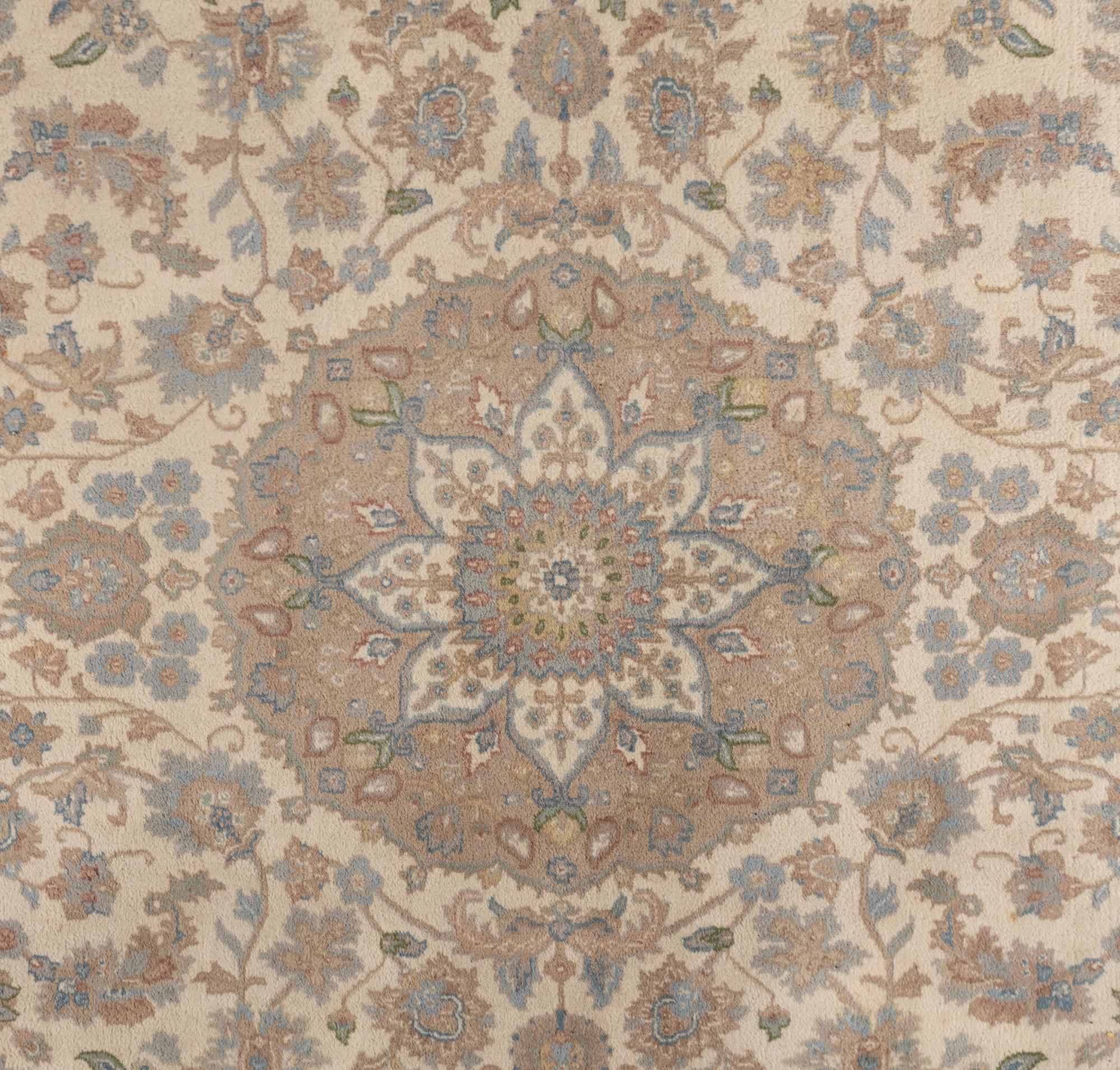An Ivory and Pastel Rug