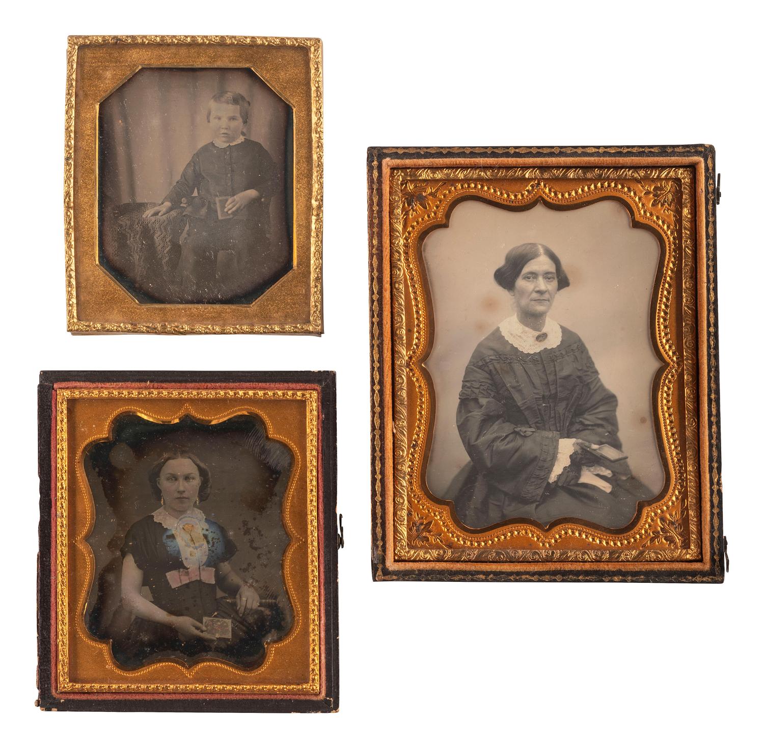 [EARLY PHOTOGRAPHY]. A group of 23 daguerreotypes featuring subjects posed with cased images, including:
