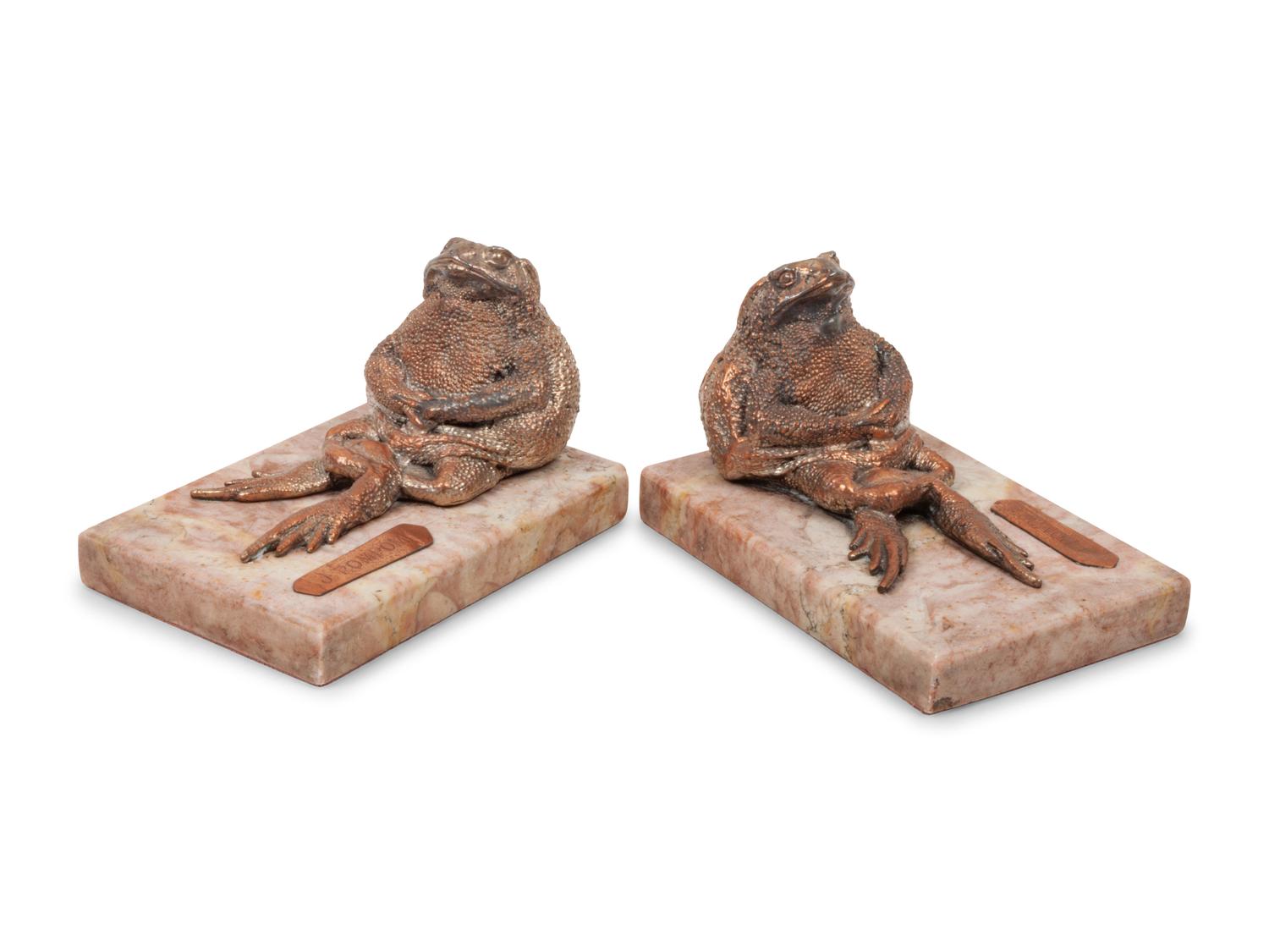 A Pair of Silvered Copper and Marble Bookends