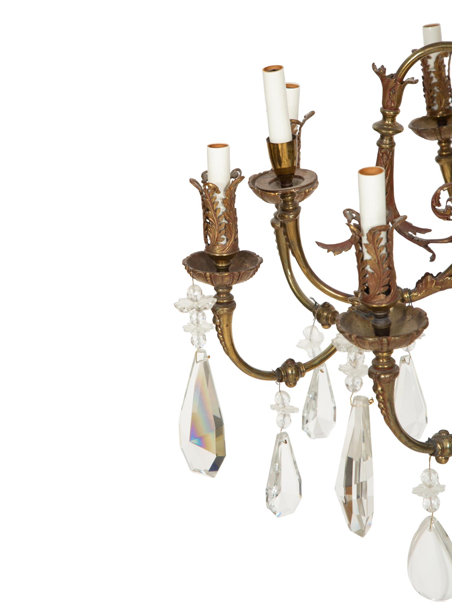 A Pierced Brass Eight-Light Chandelier with Crystal Drops