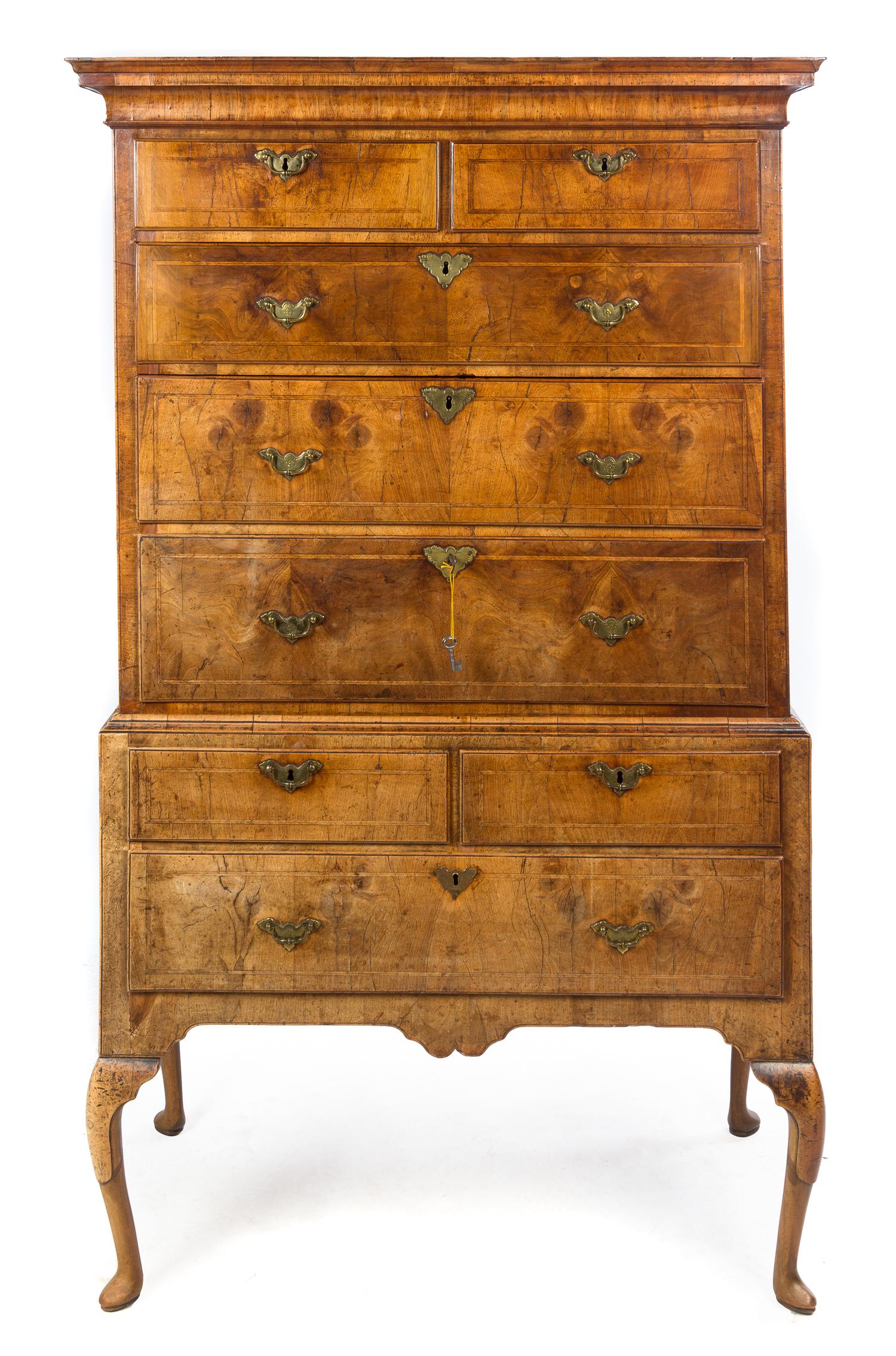 A George I Feather Banded Walnut Chest on Stand Height 69 x width 41 1/4 x depth 22 1/4 inches. — EARLY 18TH CENTURY