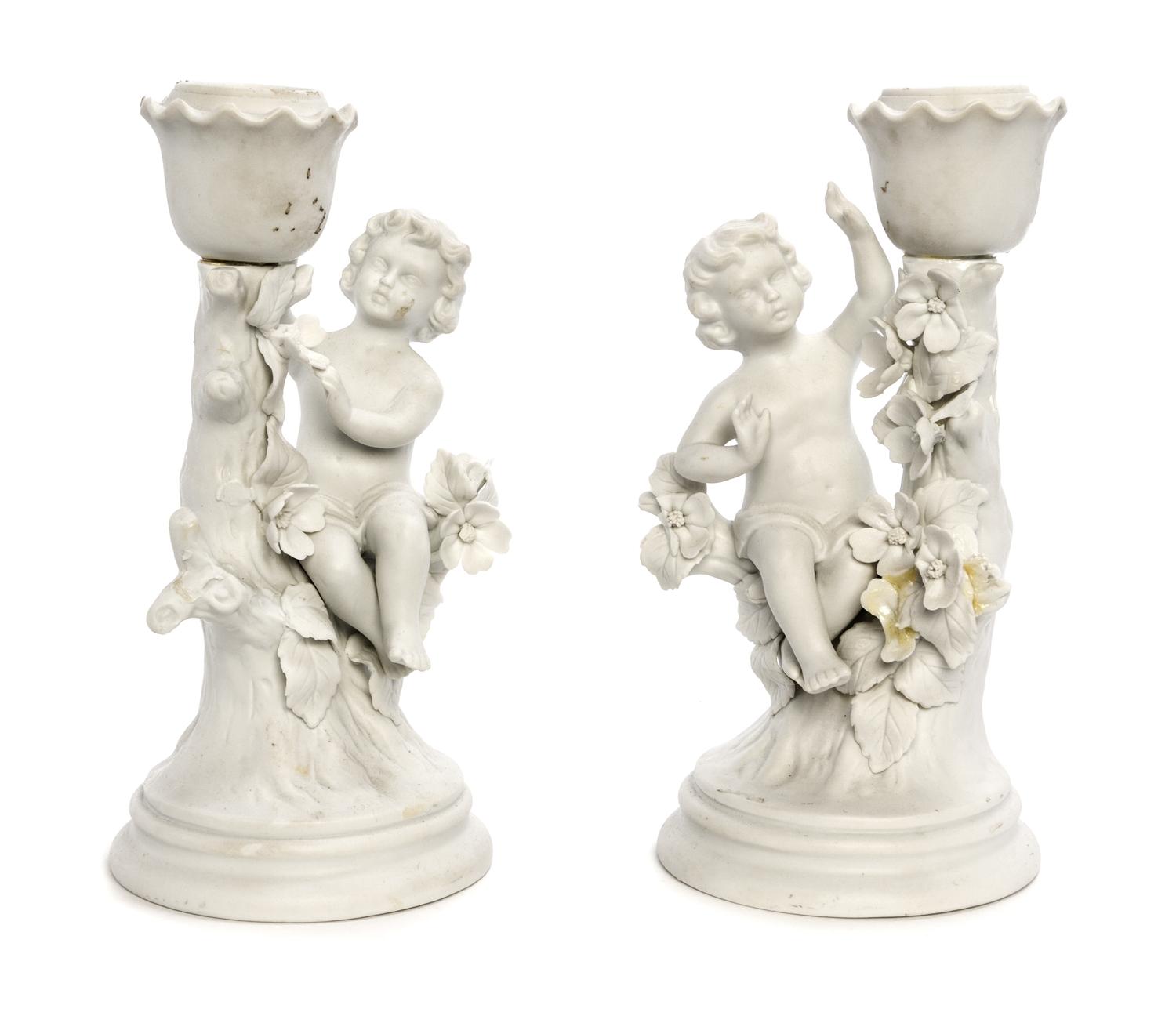 A Pair of Bisque Porcelain Figural Candlesticks Height 7 1/4 inches.