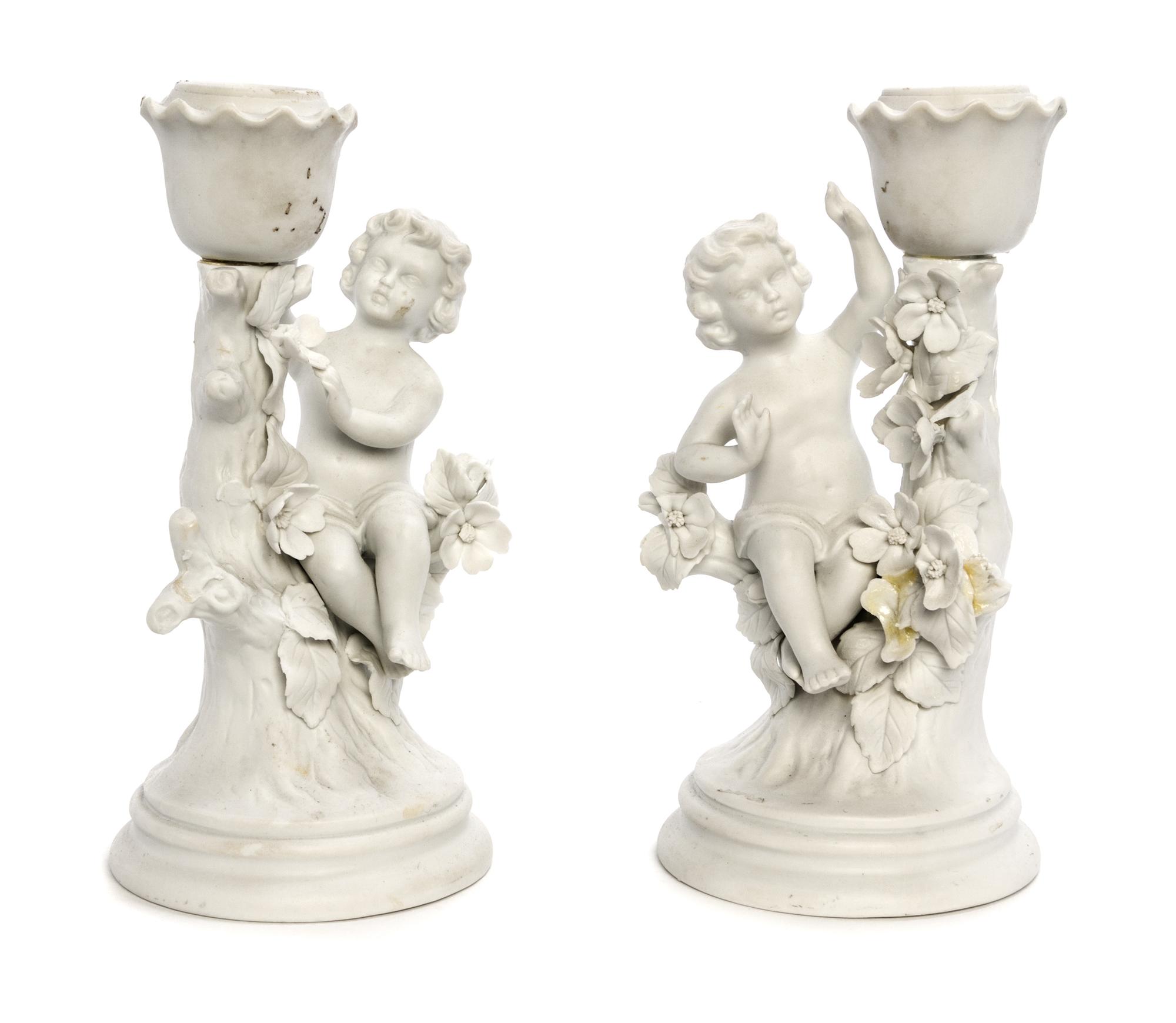 A Pair of Bisque Porcelain Figural Candlesticks Height 7 1/4 inches.