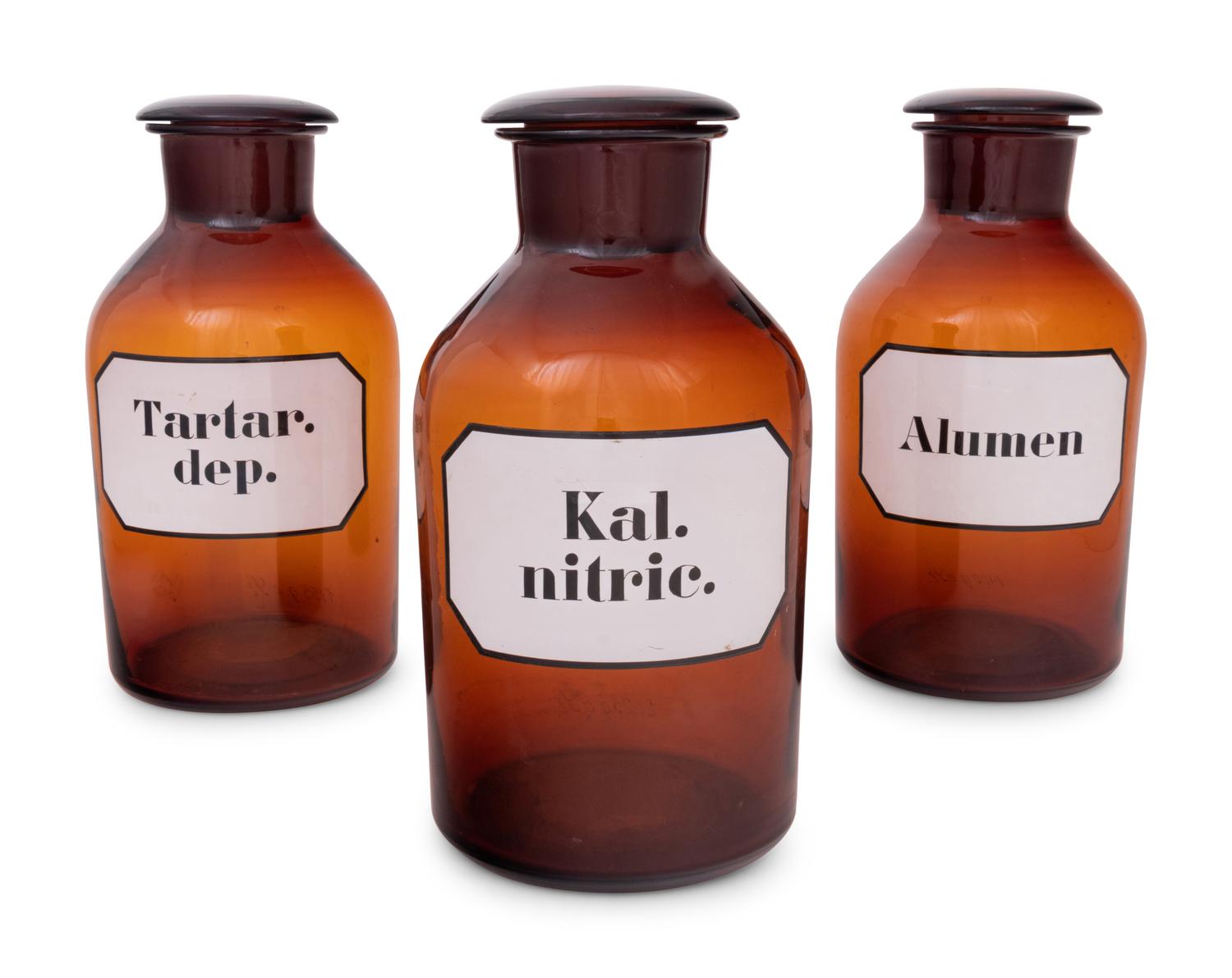 A Set of Three Large Amber Glass Apothecary Jars