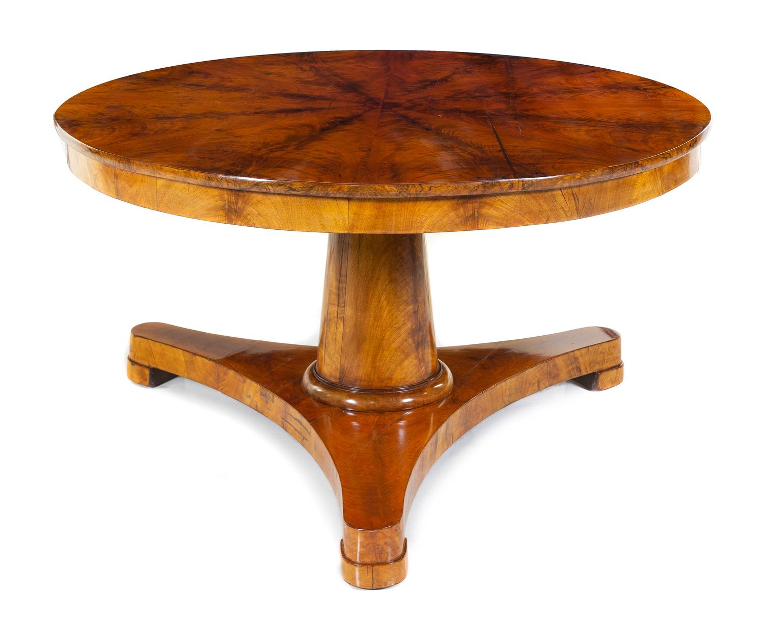 A Biedermeier Mahogany Center Table Height 29 x diameter of top 52 3/4 inches. — SECOND QUARTER 19TH CENTURY