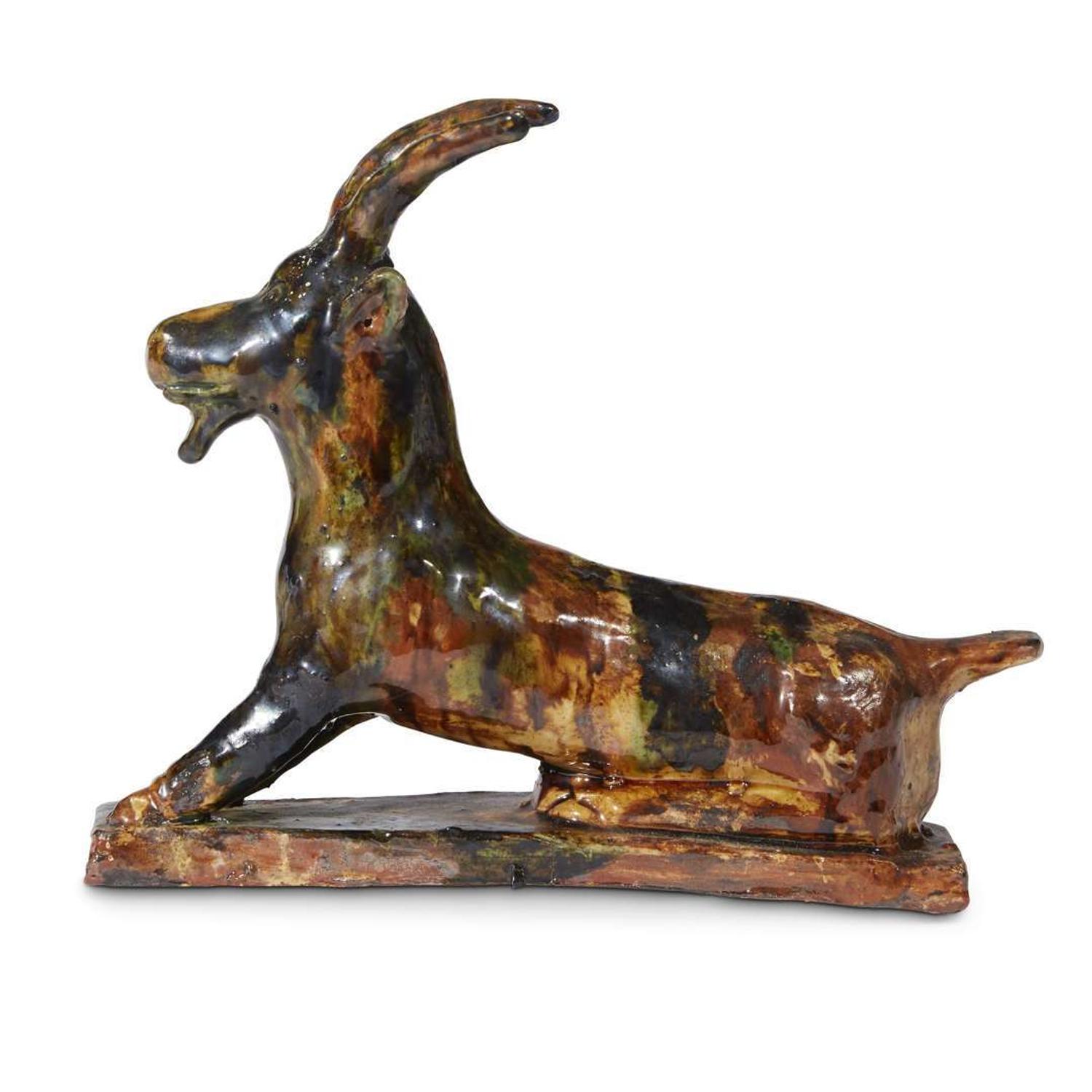 Glazed redware figure of a reclining goat Robert Stauffer, late 20th century