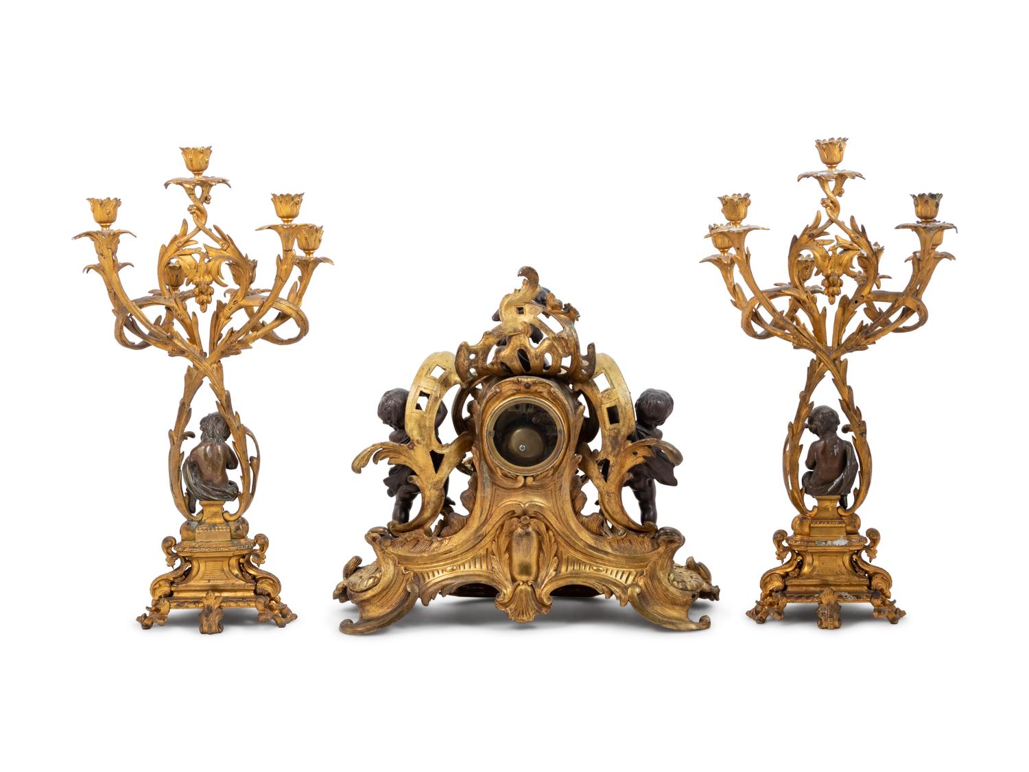 A Louis XV Style Gilt and Patinated Bronze Clock Garniture