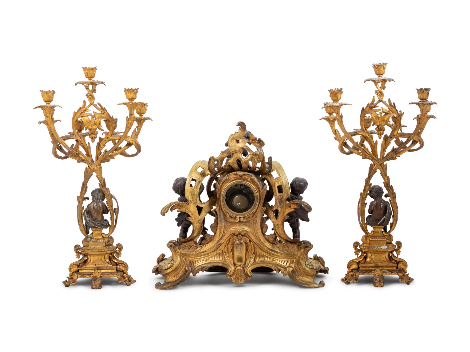 A Louis XV Style Gilt and Patinated Bronze Clock Garniture