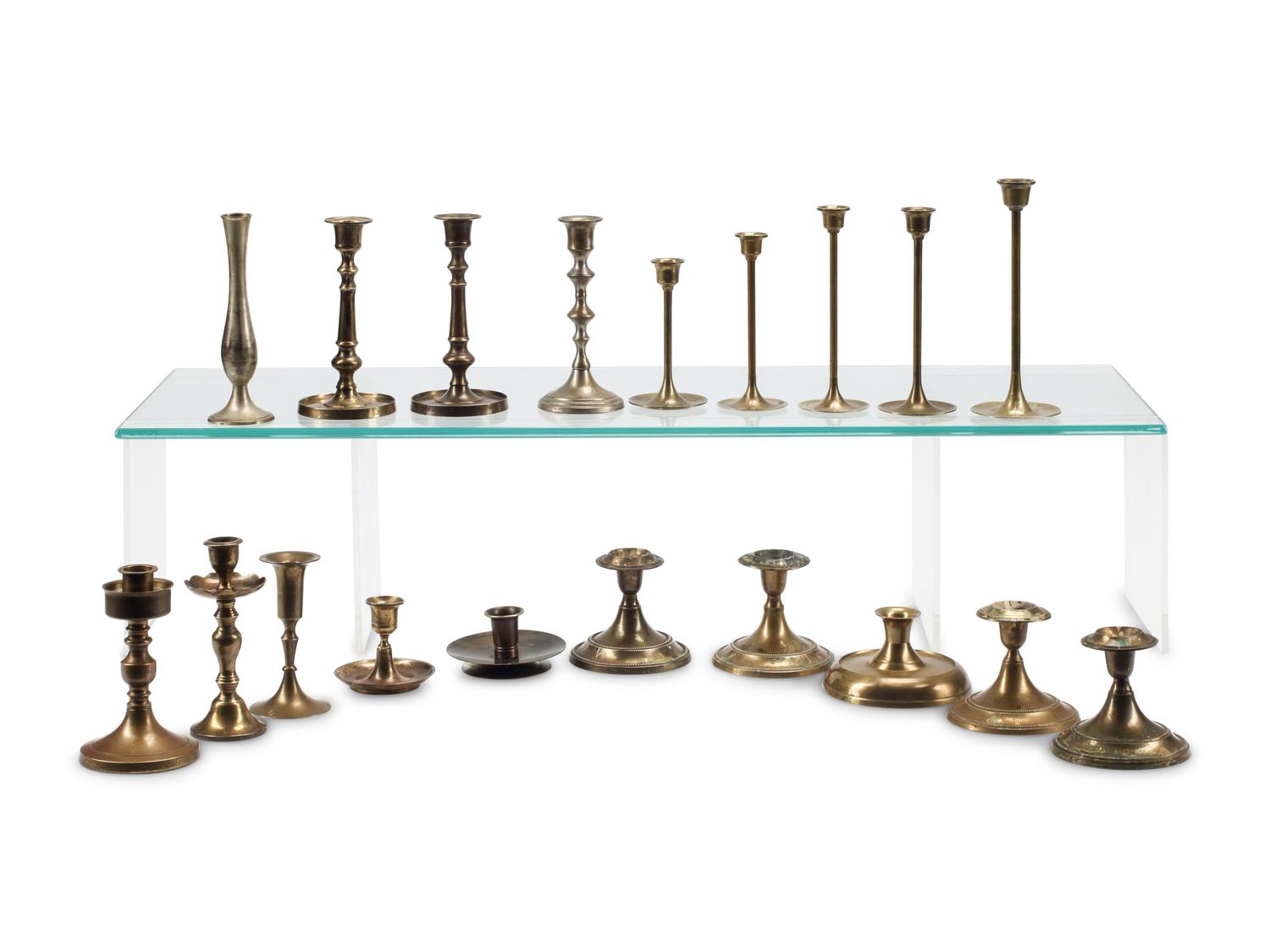 A Collection of Nineteen Brass Candlesticks