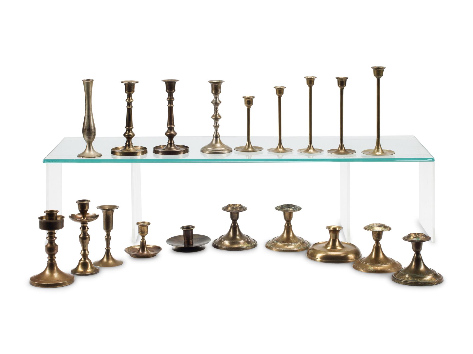 A Collection of Nineteen Brass Candlesticks