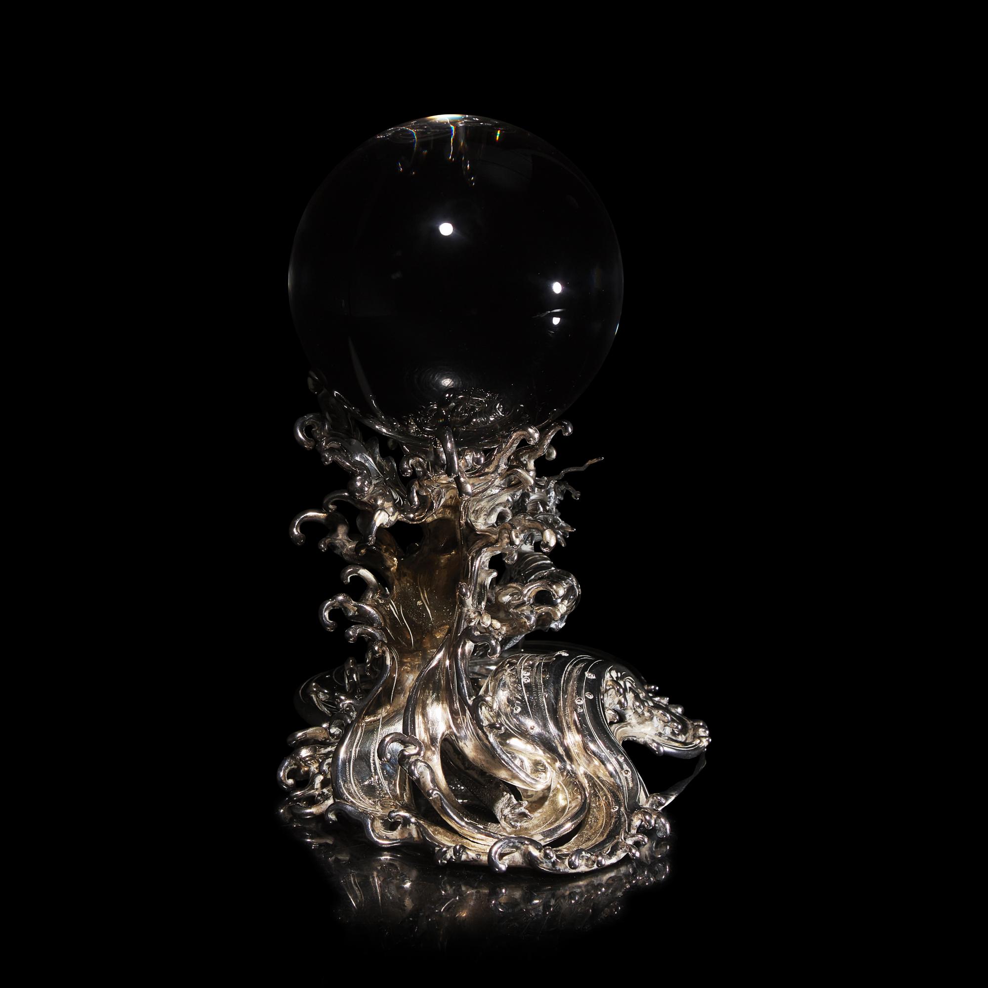 A Japanese Rock Crystal Sphere and Silver 'Dragon and Waves' Stand, Signed Yoshimasa Saku Meiji/Taisho Period 日本明治/大正時期 義正作潮を支配する珠と龍