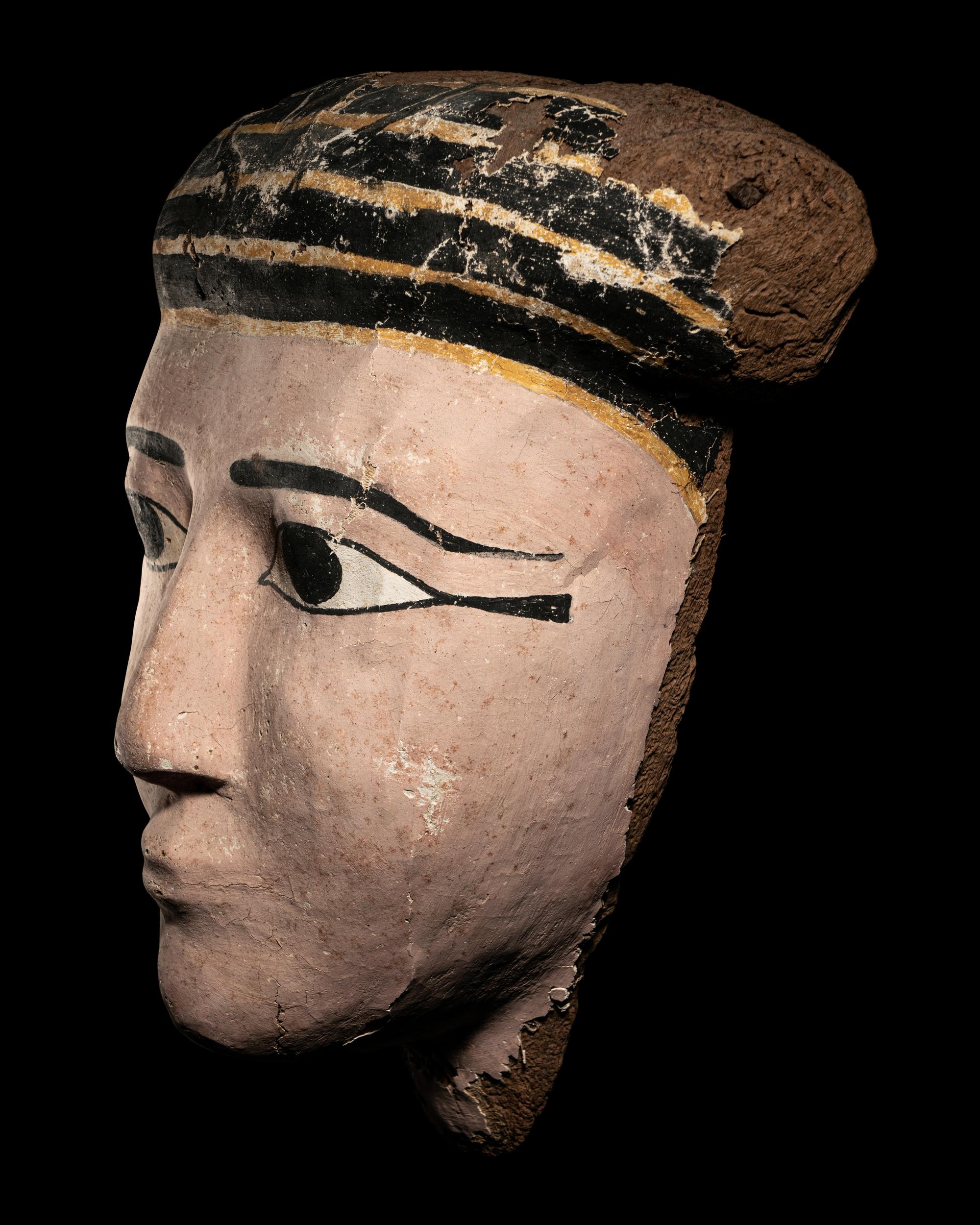 An Egyptian Wood and Painted Cartonnage Mummy Mask