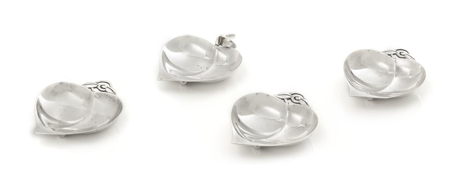 A Group of Four American Silver Nut Dishes, Tiffany & Co., New York, NY, the leaf form dish with a similarly decorated handle.