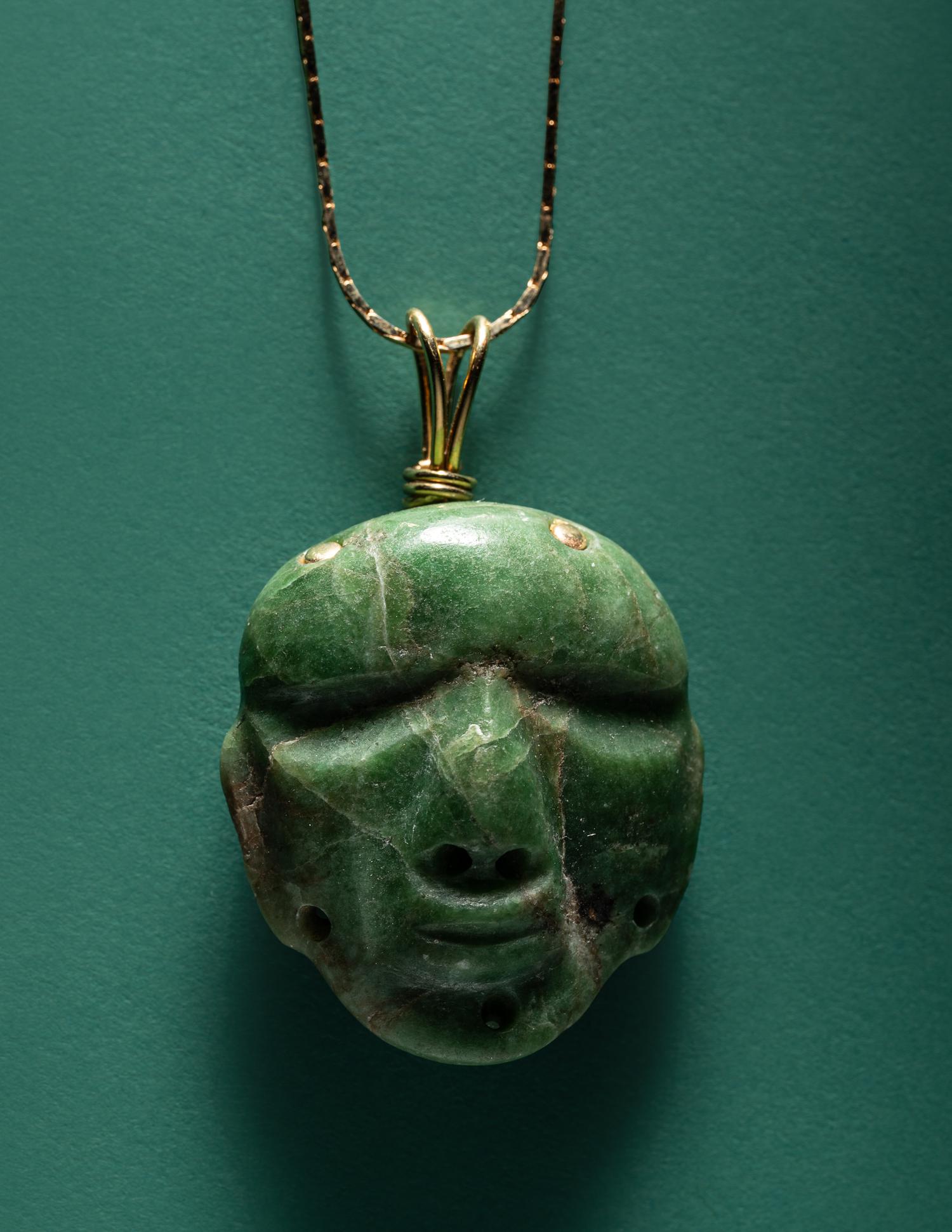 A Chontal Jade Maskette Pendant Necklace with Gold Chain